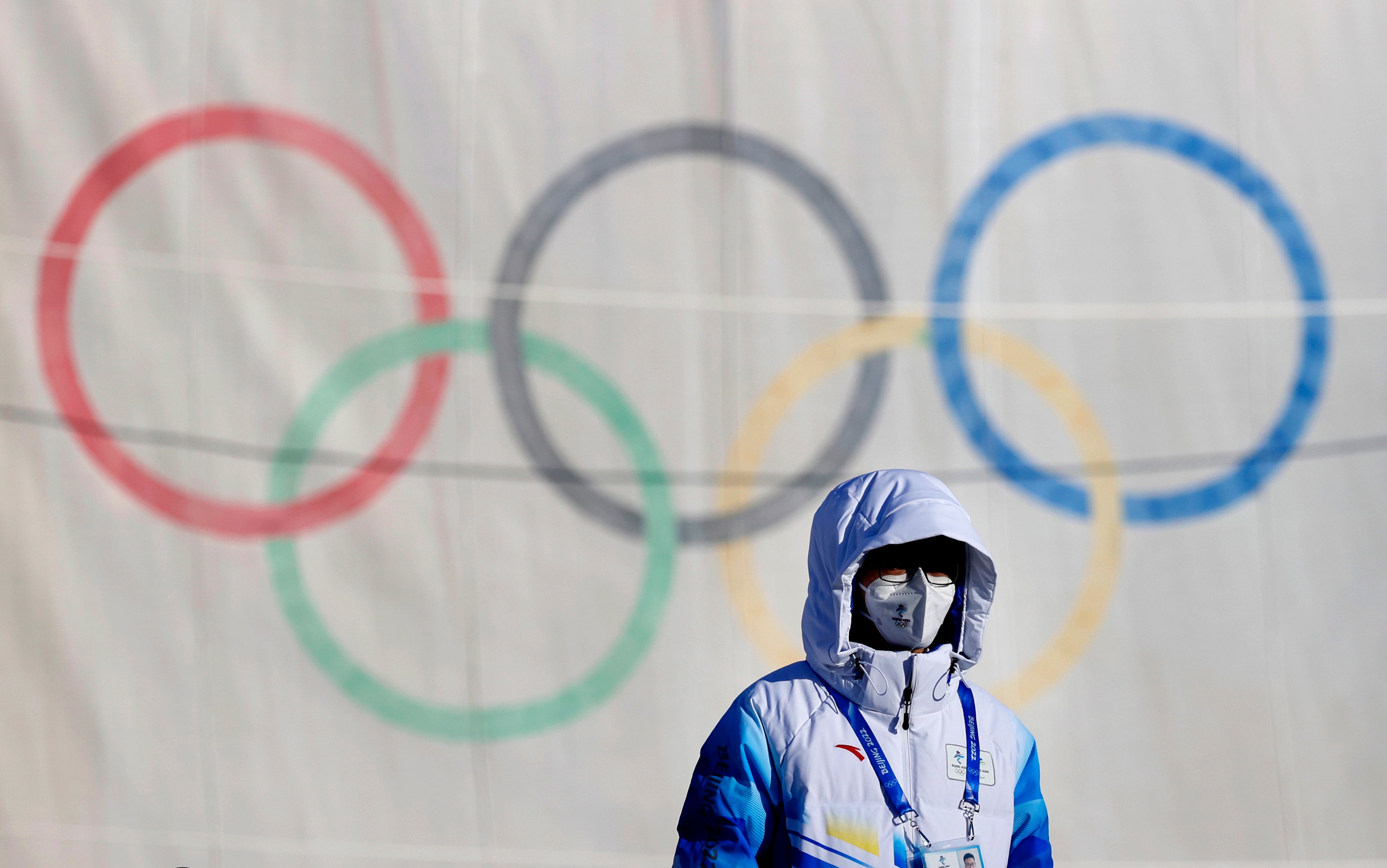 A volunteer stands next to the aerials course during preparations for the Beijing 2022 Winter Olympics, in Zhangjakou