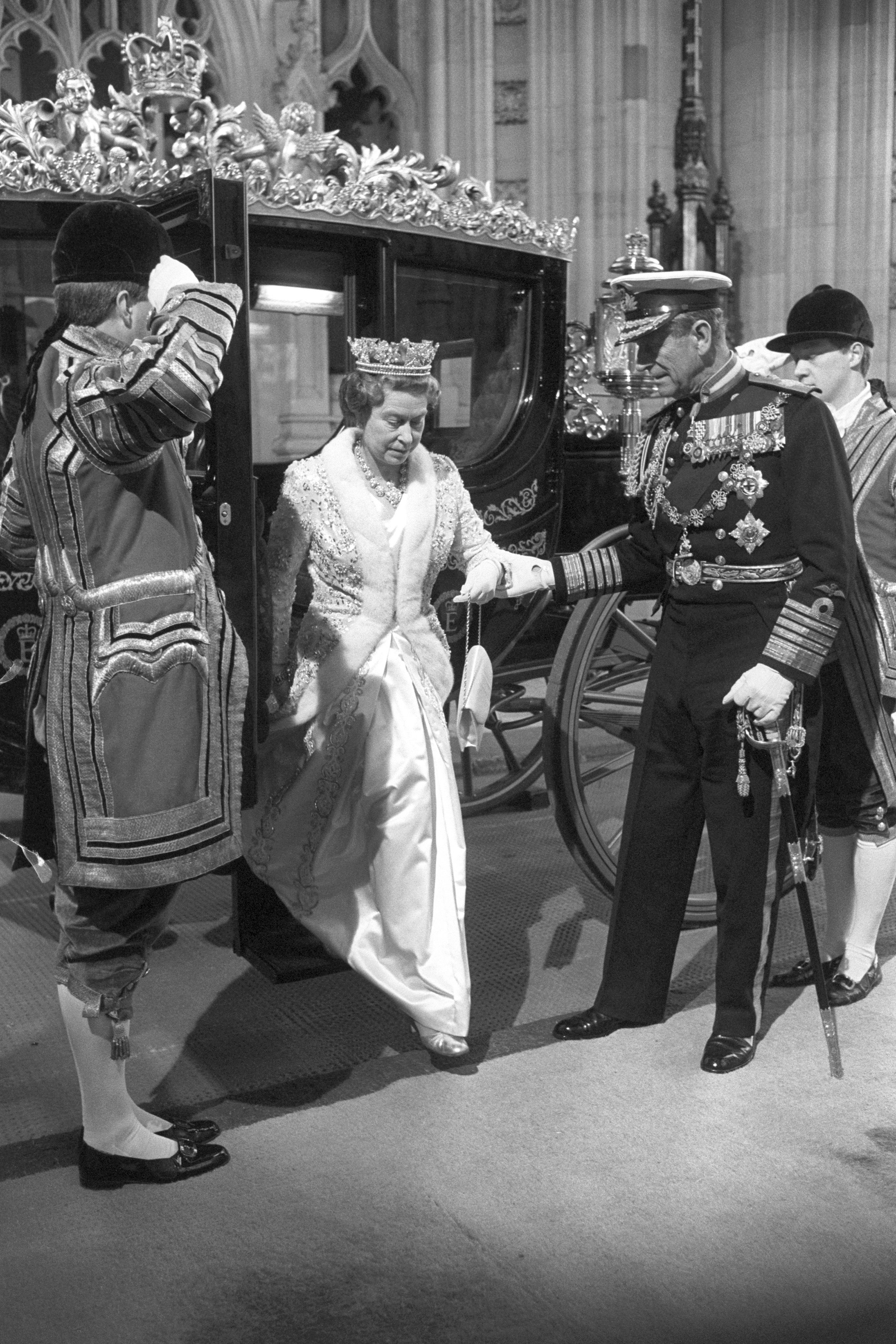 The Duke of Edinburgh helps the Queen alight from the Australia State Coach at the State Opening in 1988 (David Jones/PA)