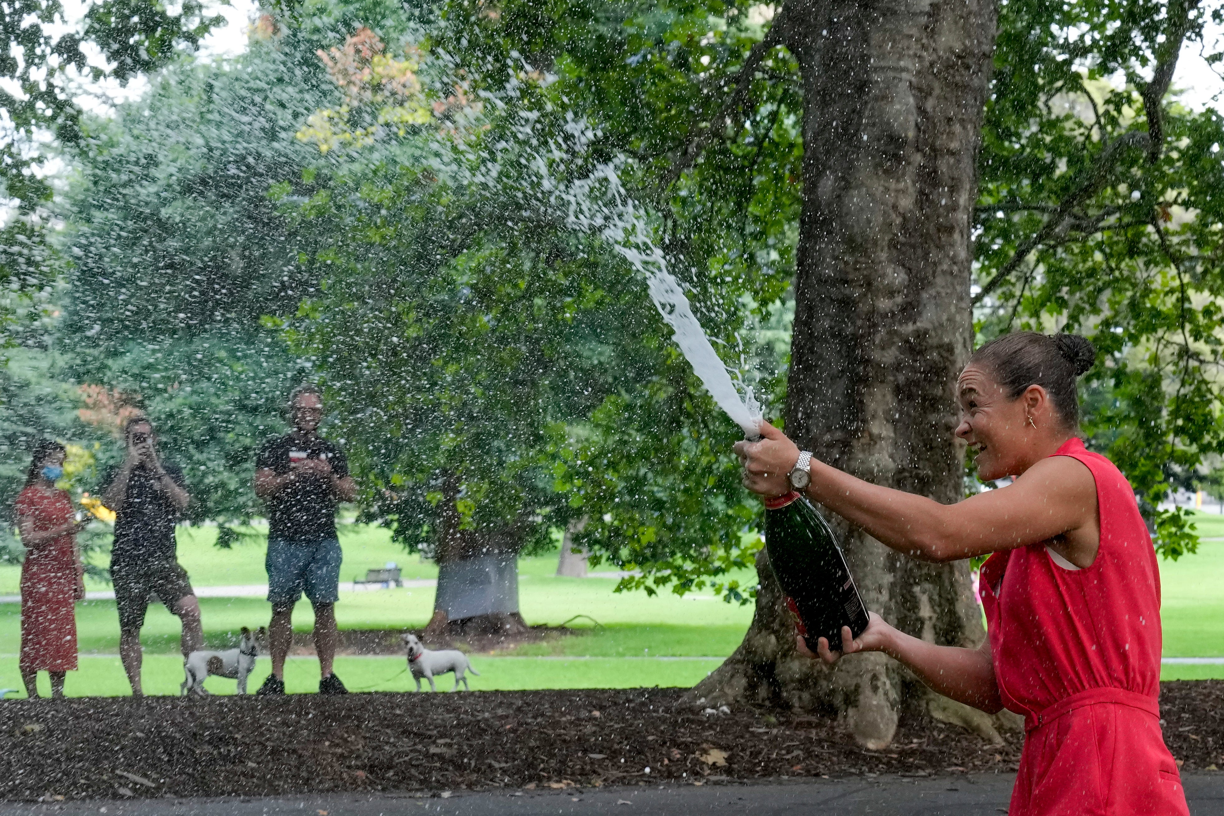 Ashleigh Barty celebrates her victory with champagne on Sunday morning (Mark Baker/AP)