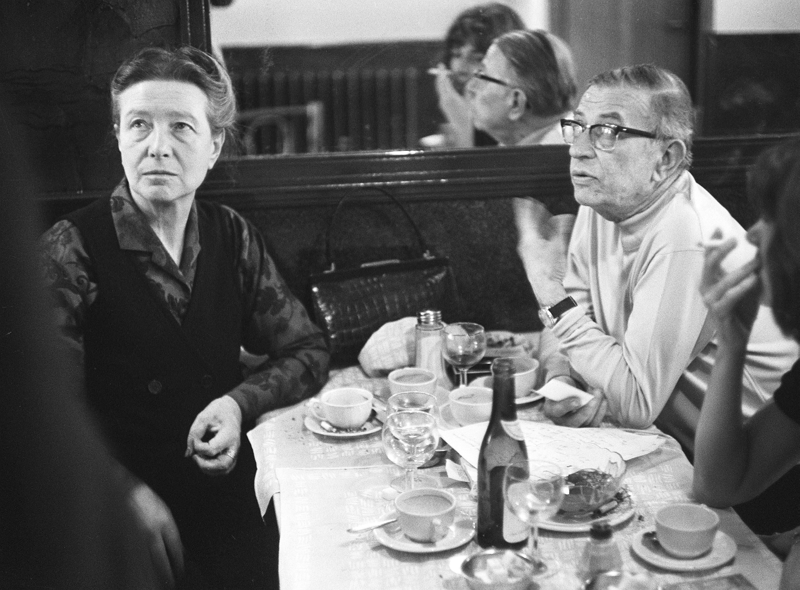 Simone de Beauvoir and Jean-Paul Sartre sitting in a cafe in Paris in 1970