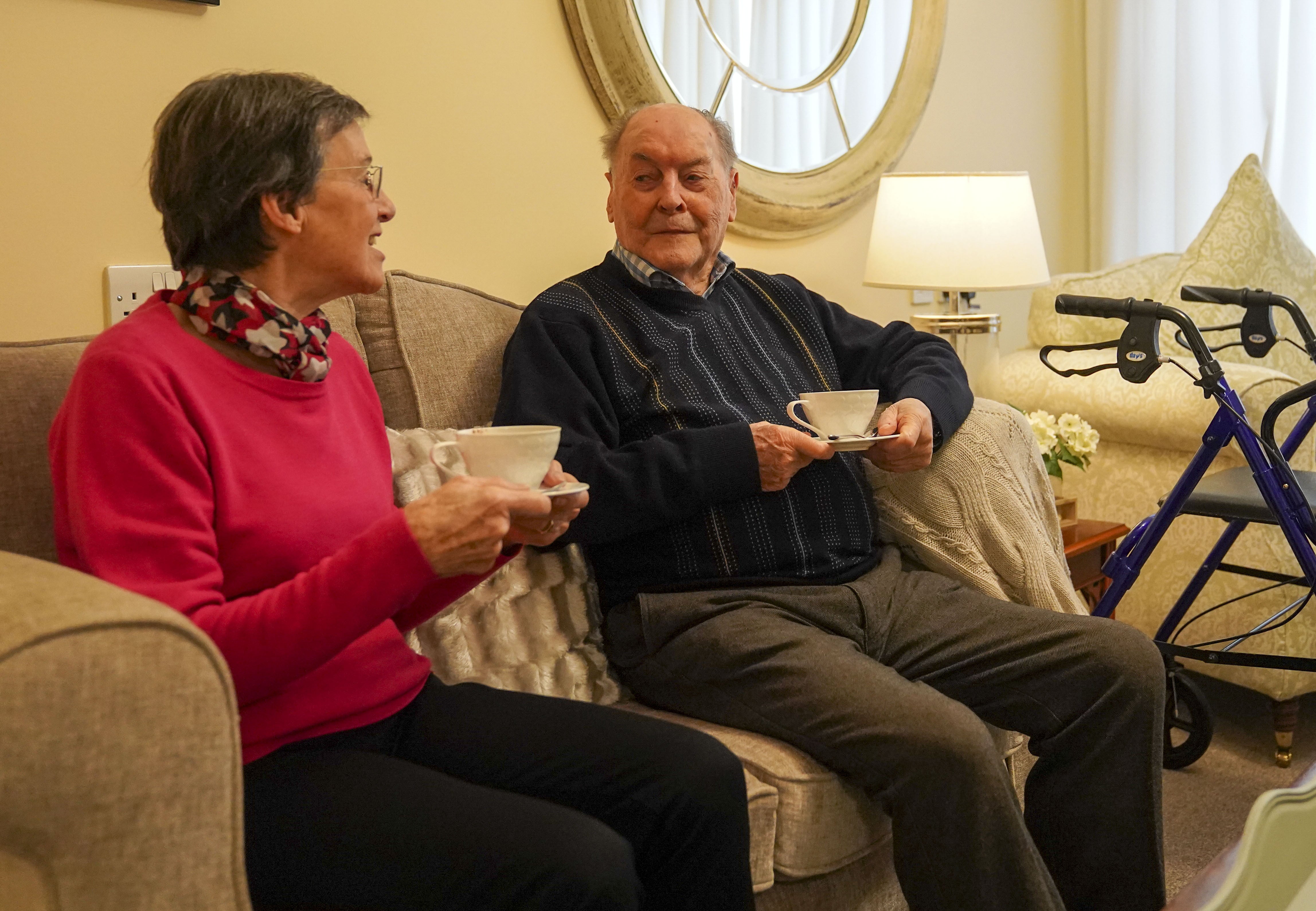 John Cooke (right), a resident in the Signature At Weybridge care home, talks with friend Val Gadd (Steve Parsons/PA(