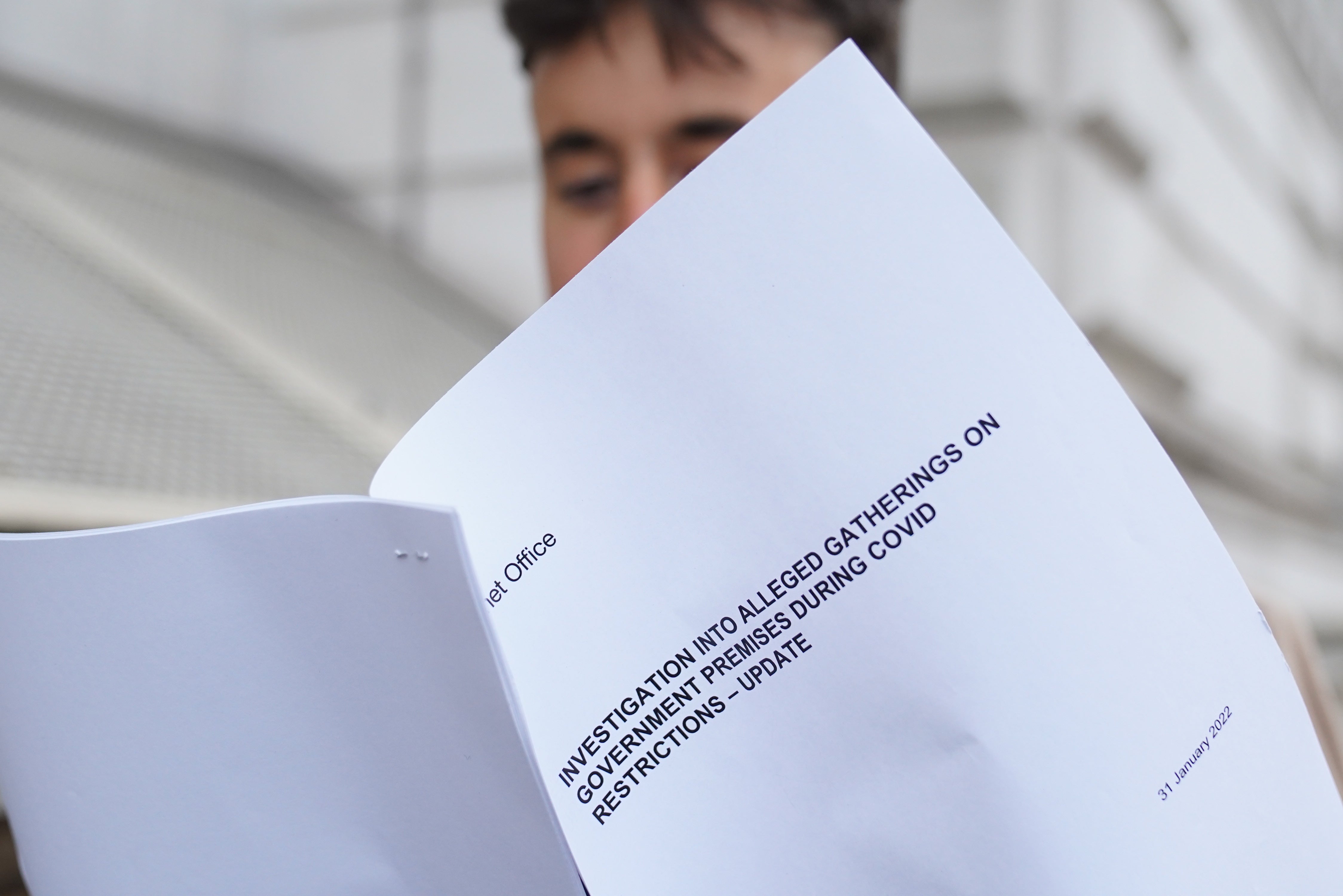 A man looks at a copy of the Sue Gray report (Stefan Rousseau/PA)