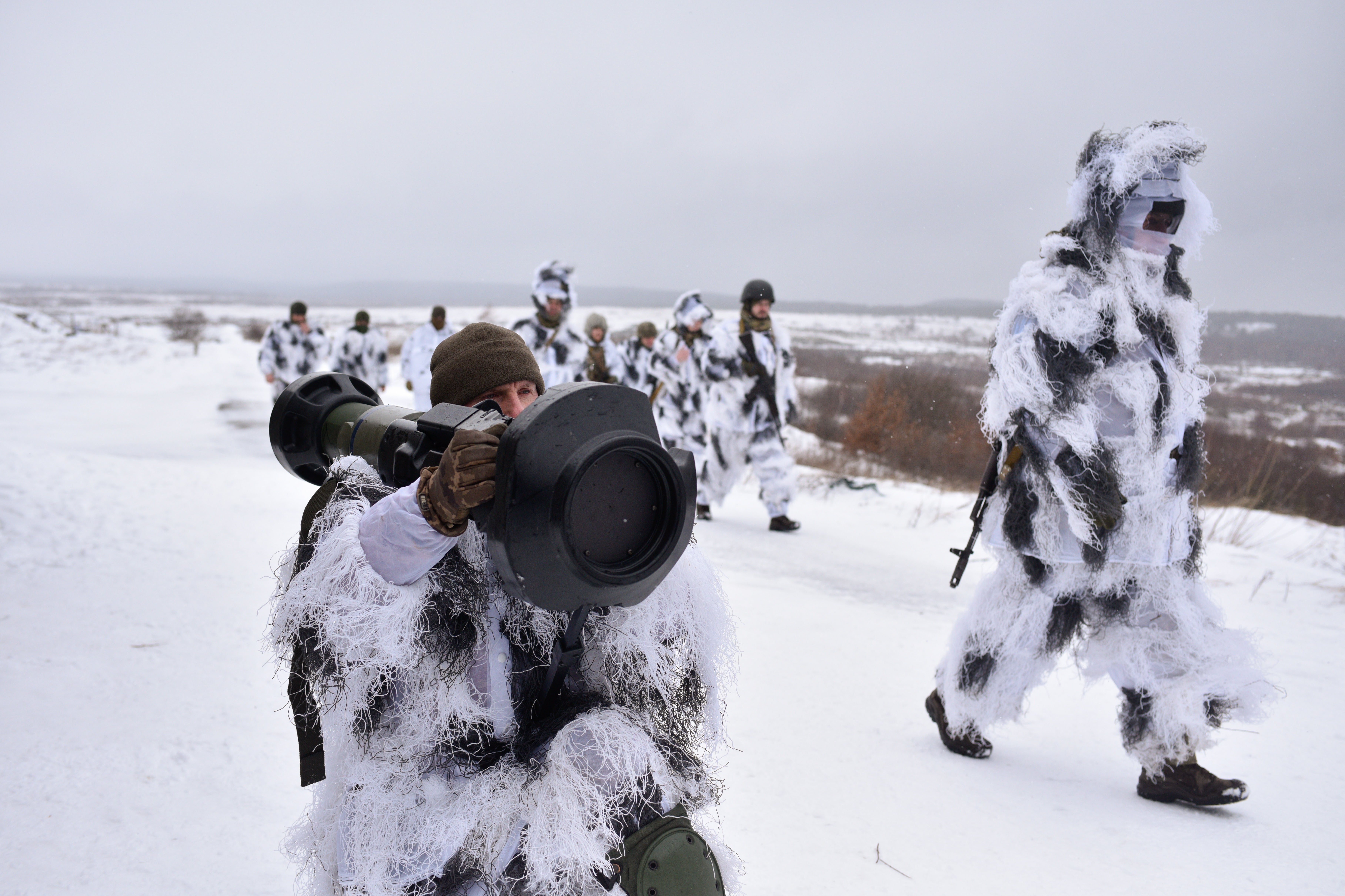 Camouflaged Ukrainian soldiers operate anti-tank missile systems at the Yavoriv military base close to the Polish border