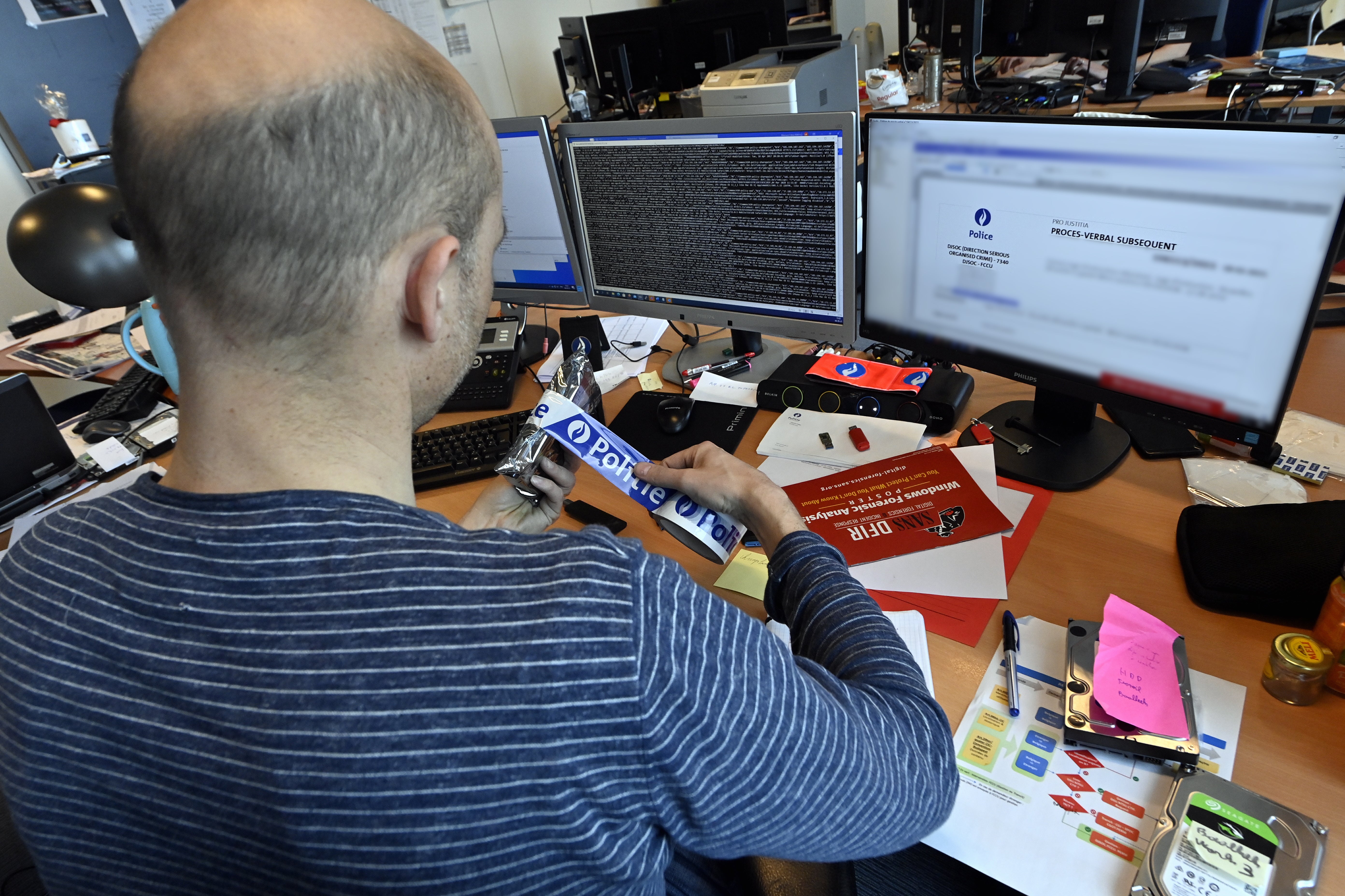 An officer working in the offices of the Federal Computer Crime Unit (FCCU) in Brussels