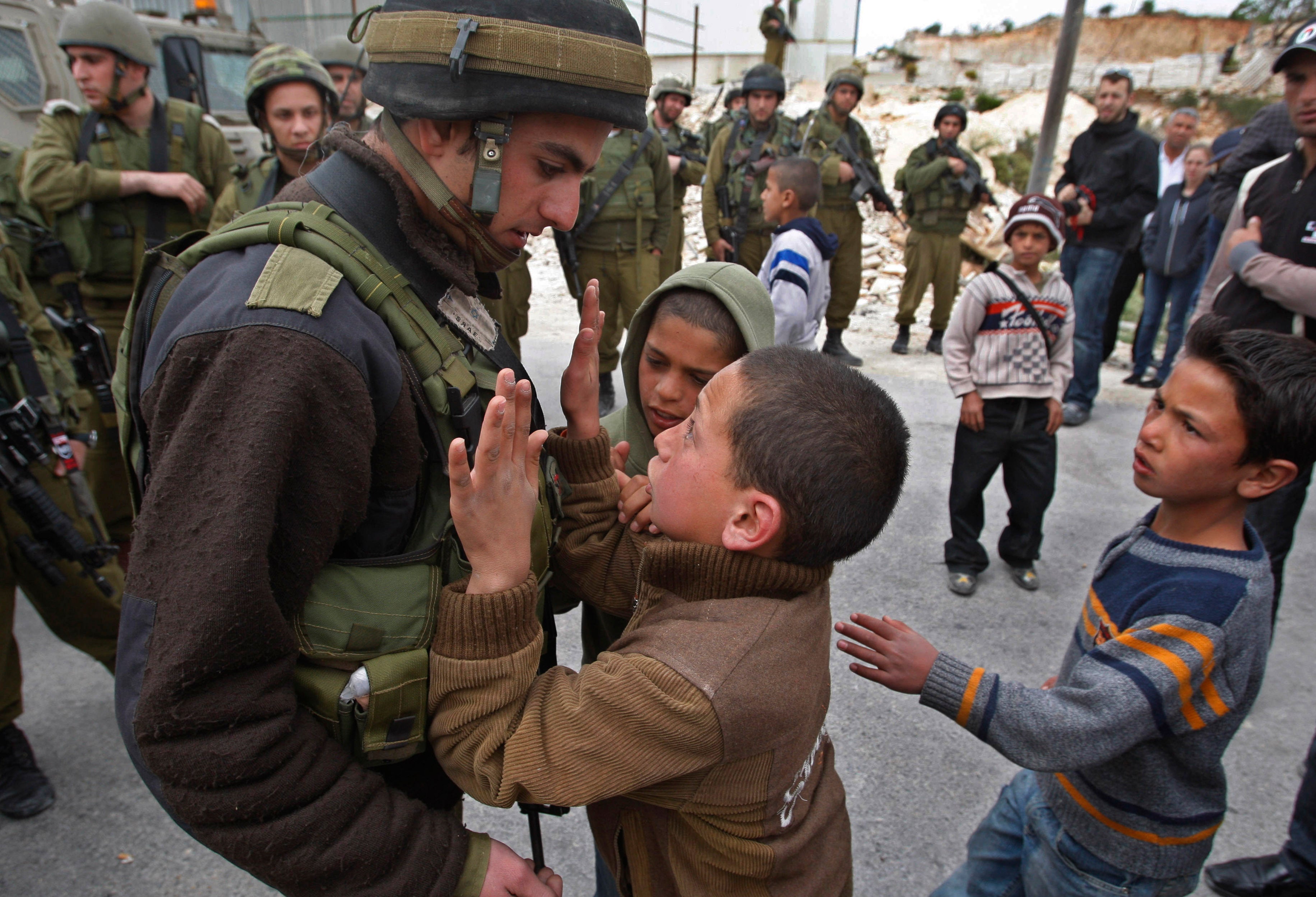 A Palestinian youth is confronted by an Israeli soldier during a demonstration against Israel’s controversial separation barrier in the village of Maasarah, near the West Bank city of Bethlehem