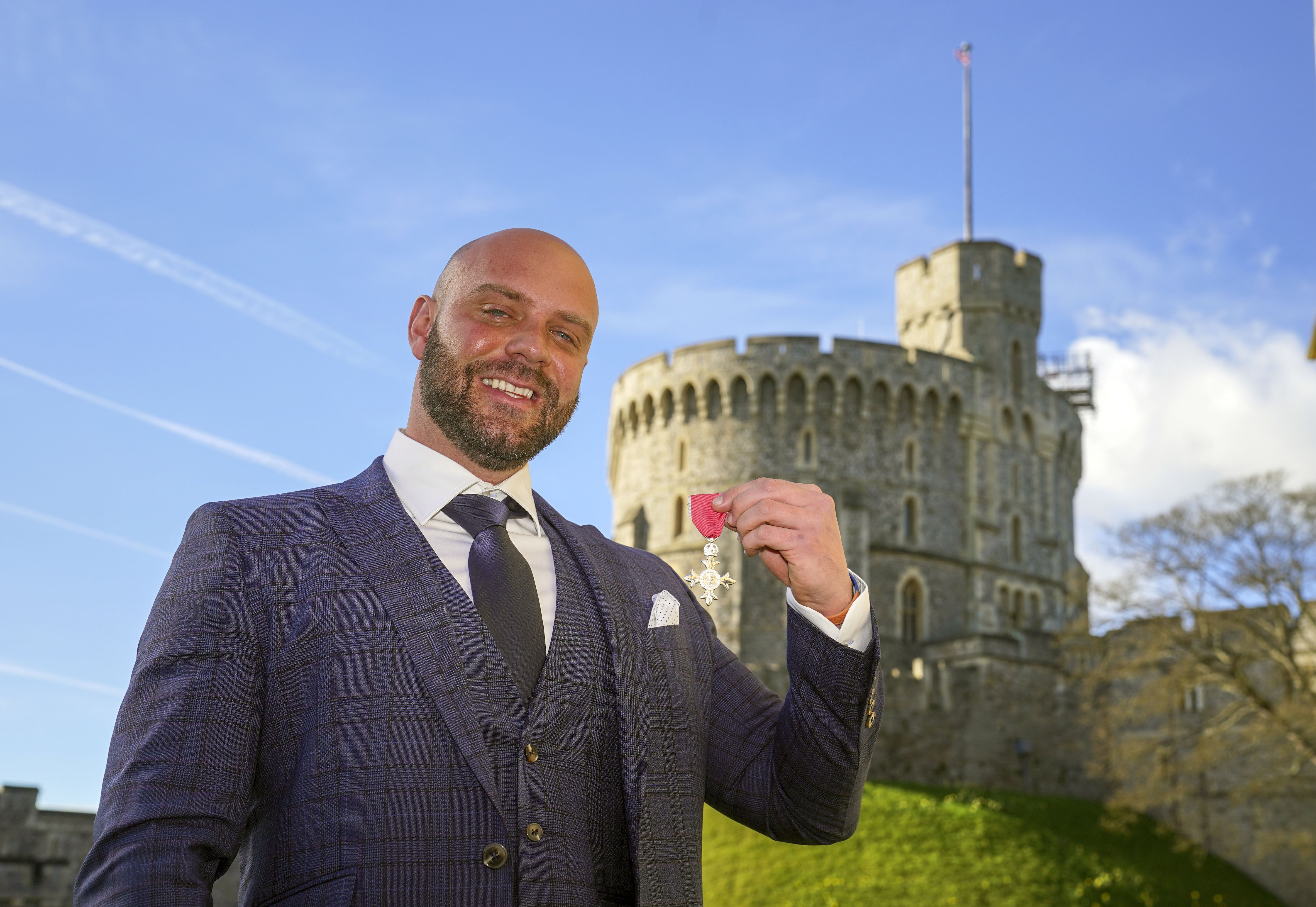 Personal trainer Mike Hind collected his MBE at Windsor Castle after walking 250 miles to get there (Steve Parsons/PA)