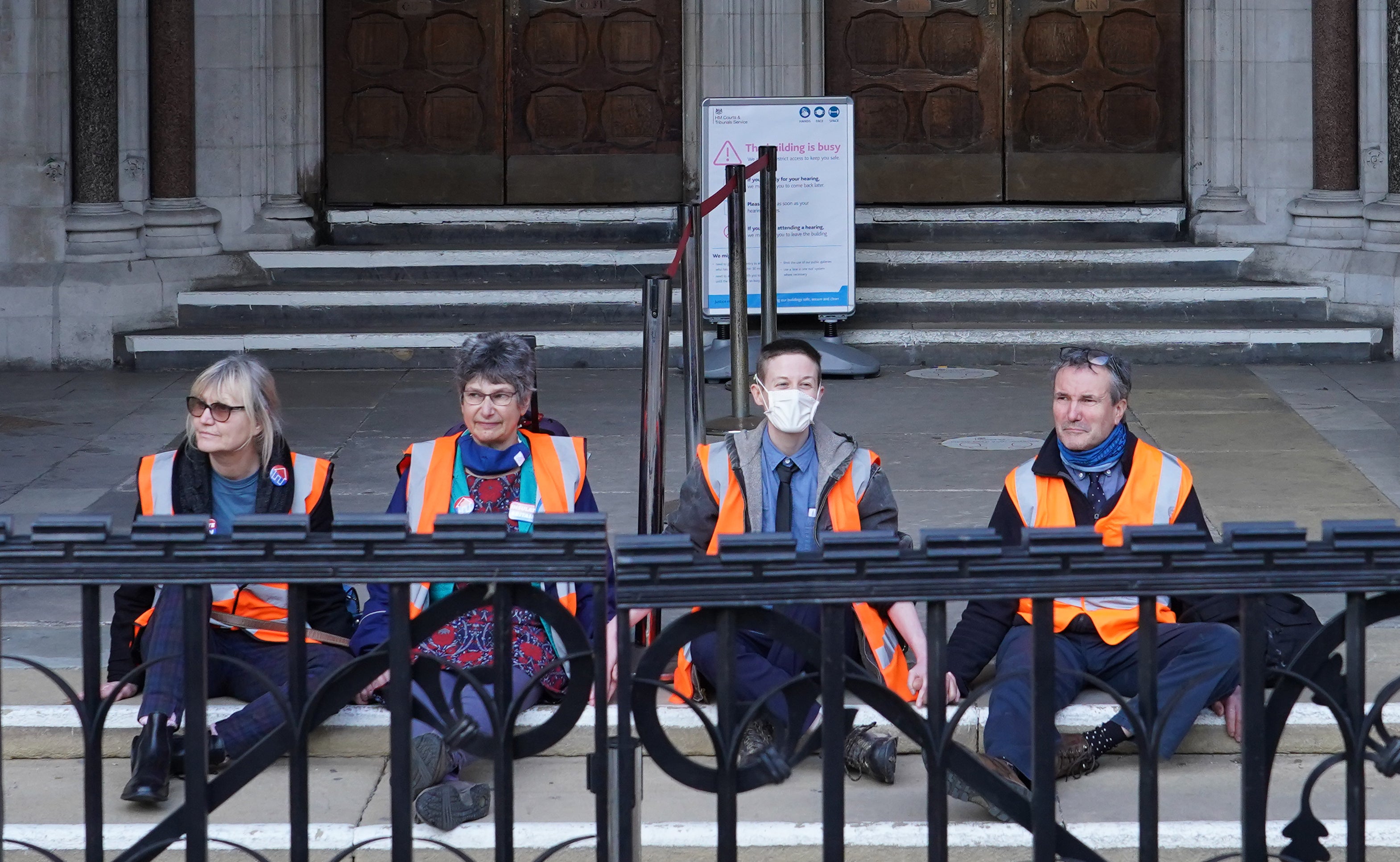 (Left to right) Insulate Britain defendants Theresa Norton, 63, Dr Diana Warner, 62, El Litten, 35 and Steve Pritchard, 62, sitting outside the Royal Courts of Justice in London, as they decided not to return to the afternoon session of their committal hearing (Ian West/PA)