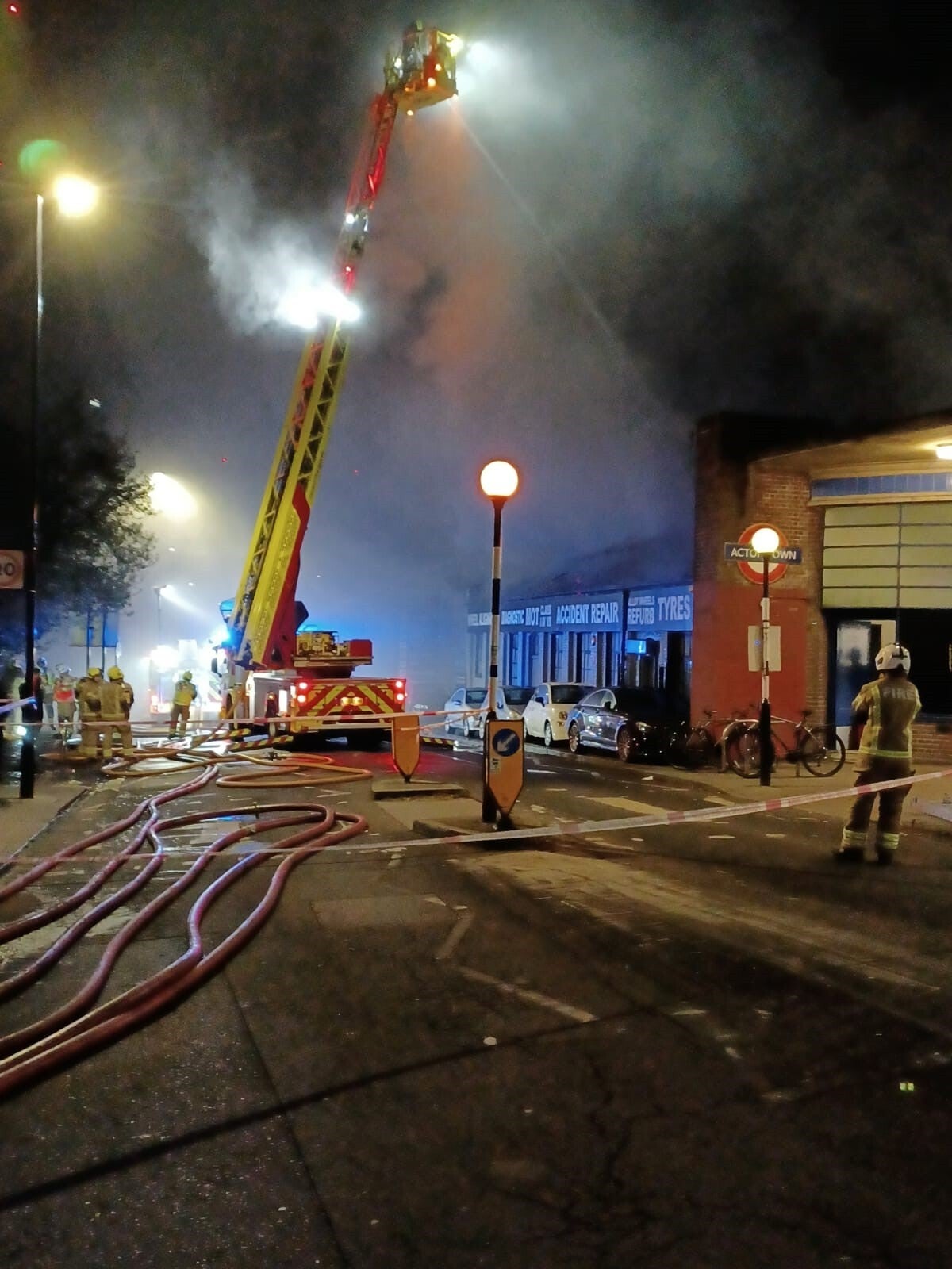 Firefighters tackle a blaze at a car garage on Bollo Lane, Acton