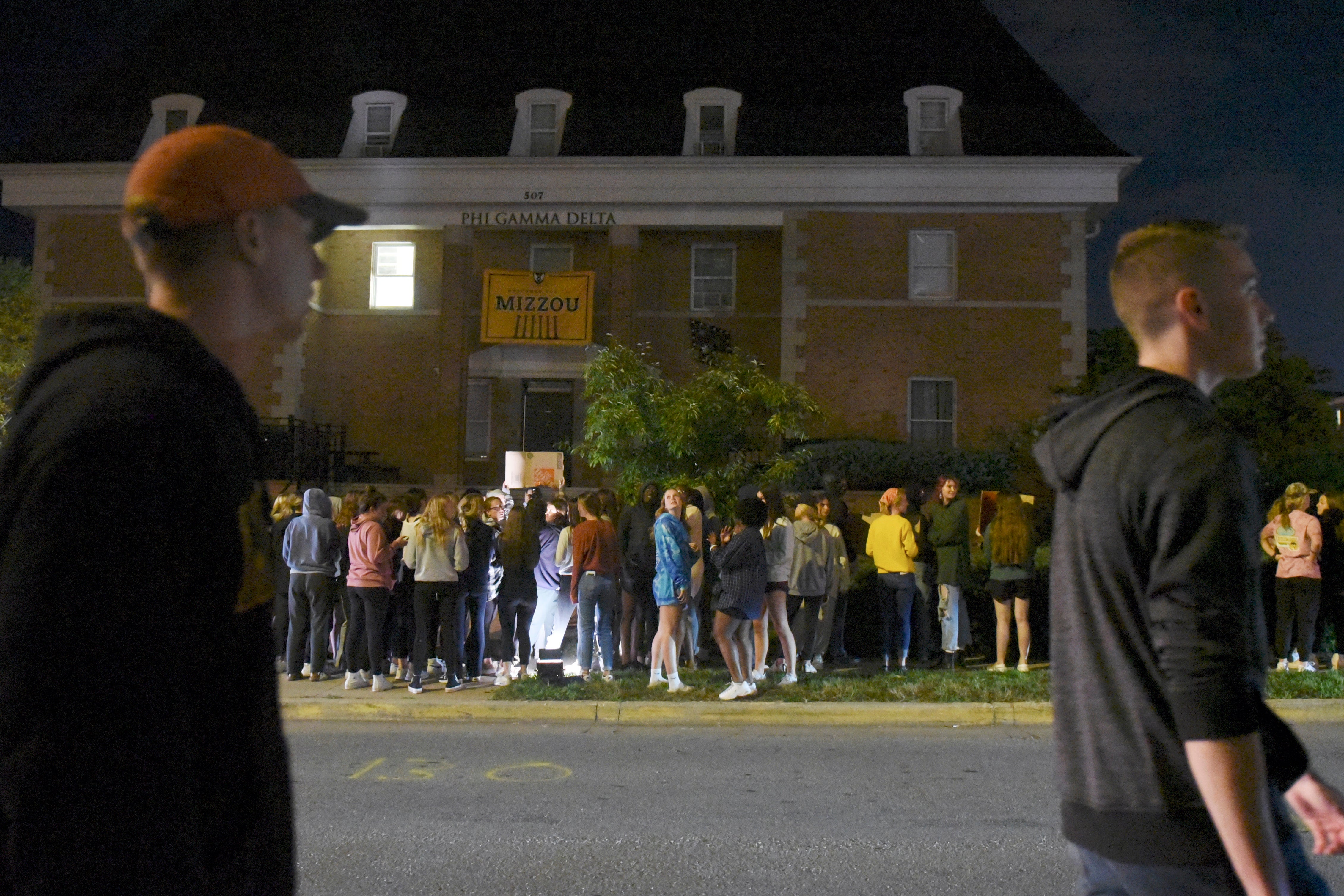 Protestors opposing fraternity hazing chant outside the Phi Gamma Delta chapter at the University of Missouri in February (File photo)