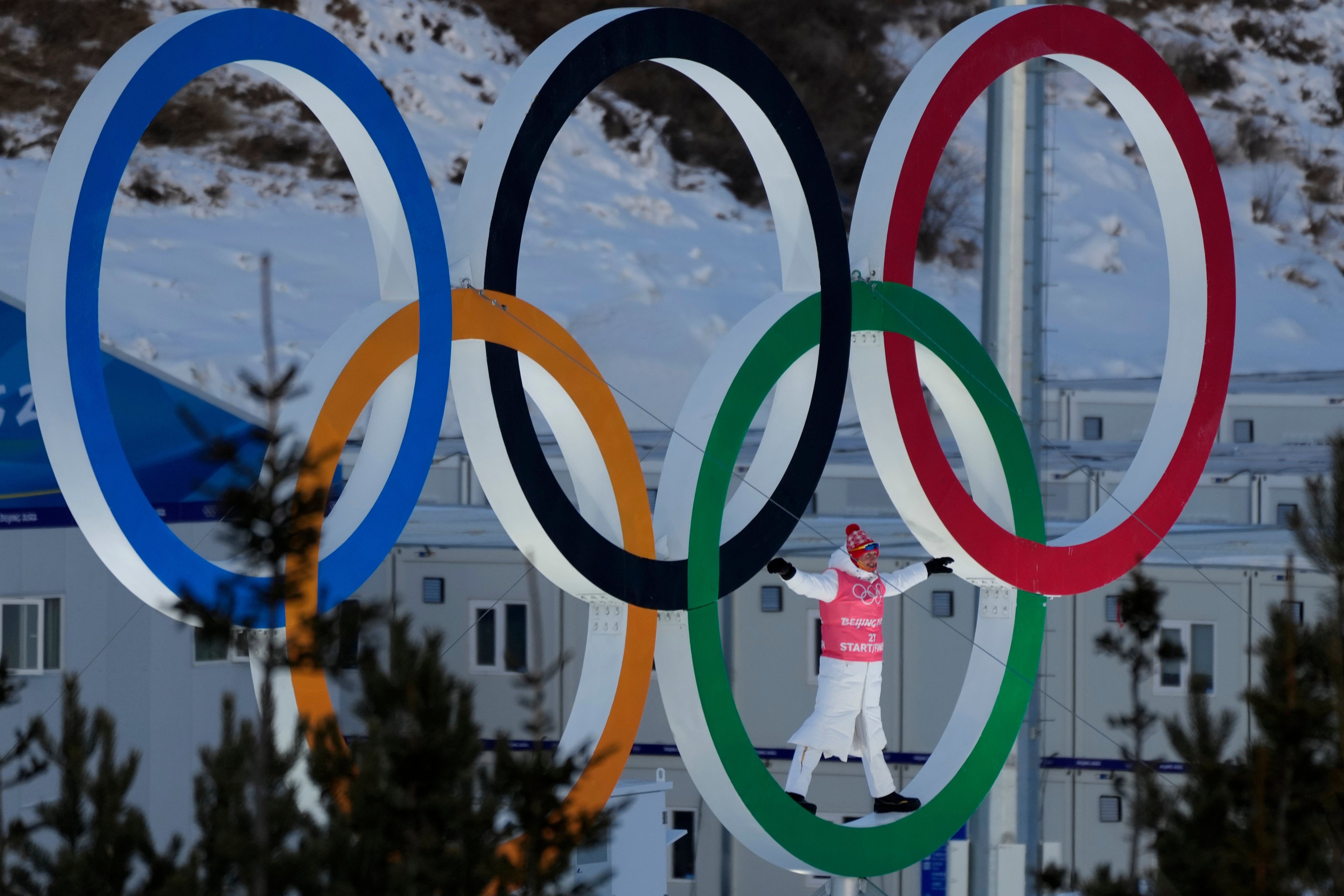 A skier stands in the Olympic Rings during a training session before the 2022 Winter Olympics in Zhangjiakou, China, 3 February 2022