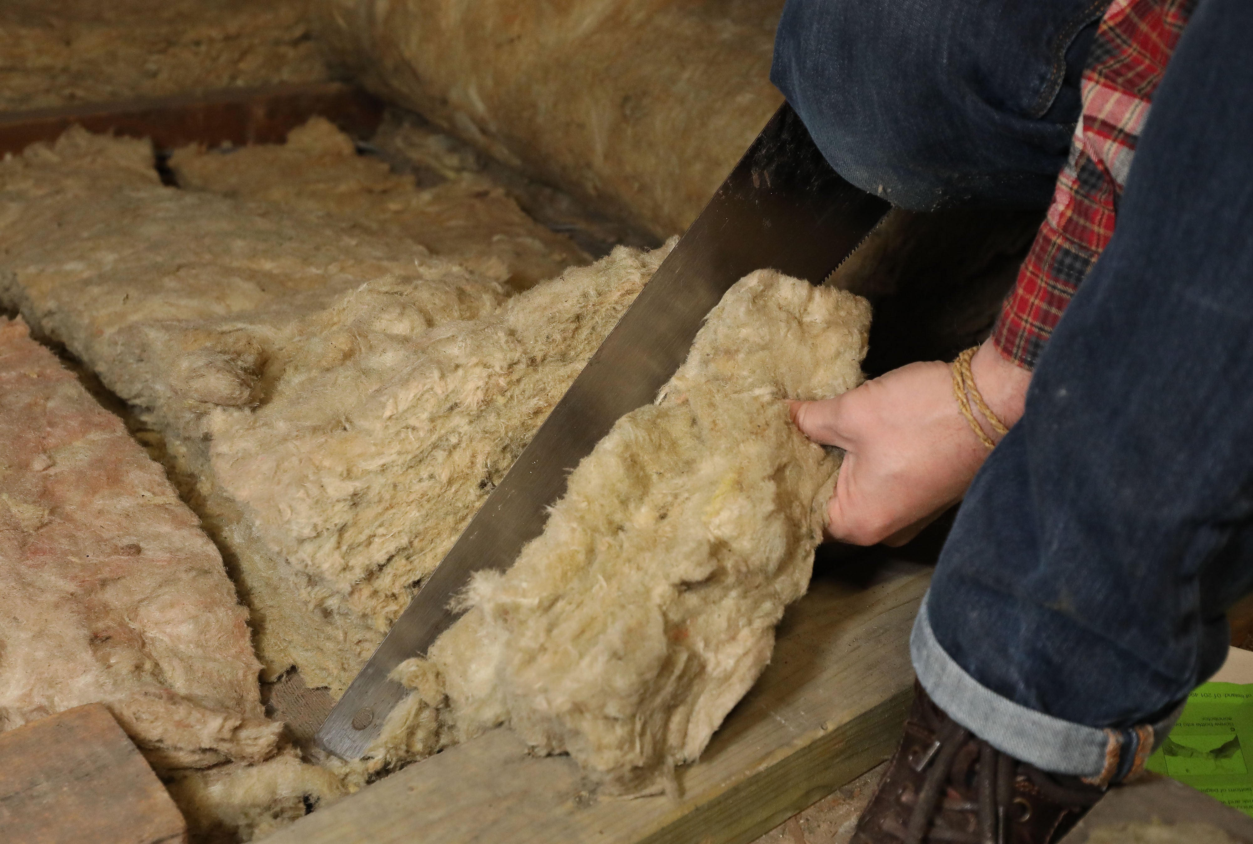 Laying loft insulation (Philip Toscano/PA)