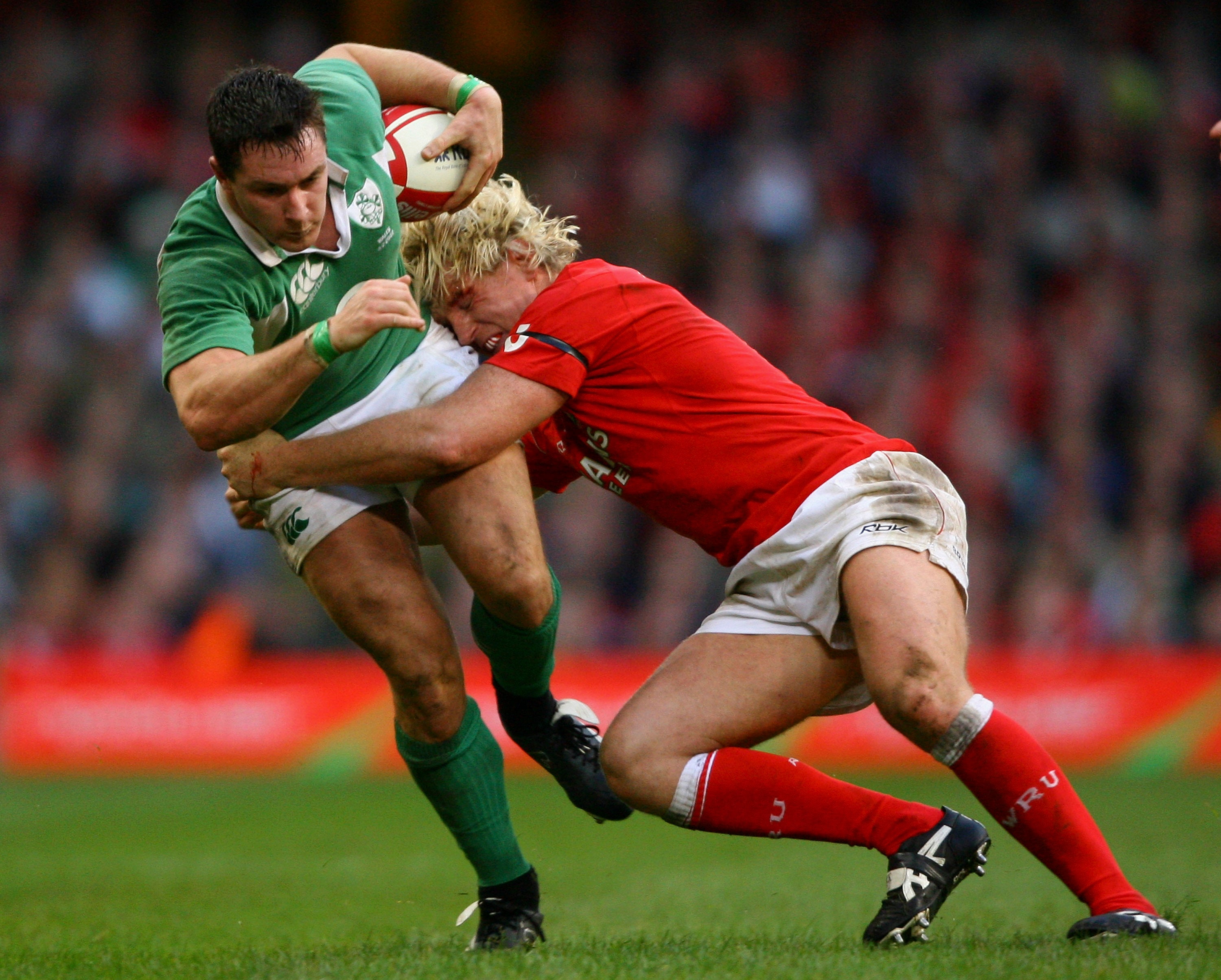 David Wallace is tackled by Popham during the Six Nations match between Wales and Ireland at Cardiff’s Millennium Stadium on 4 February 2007