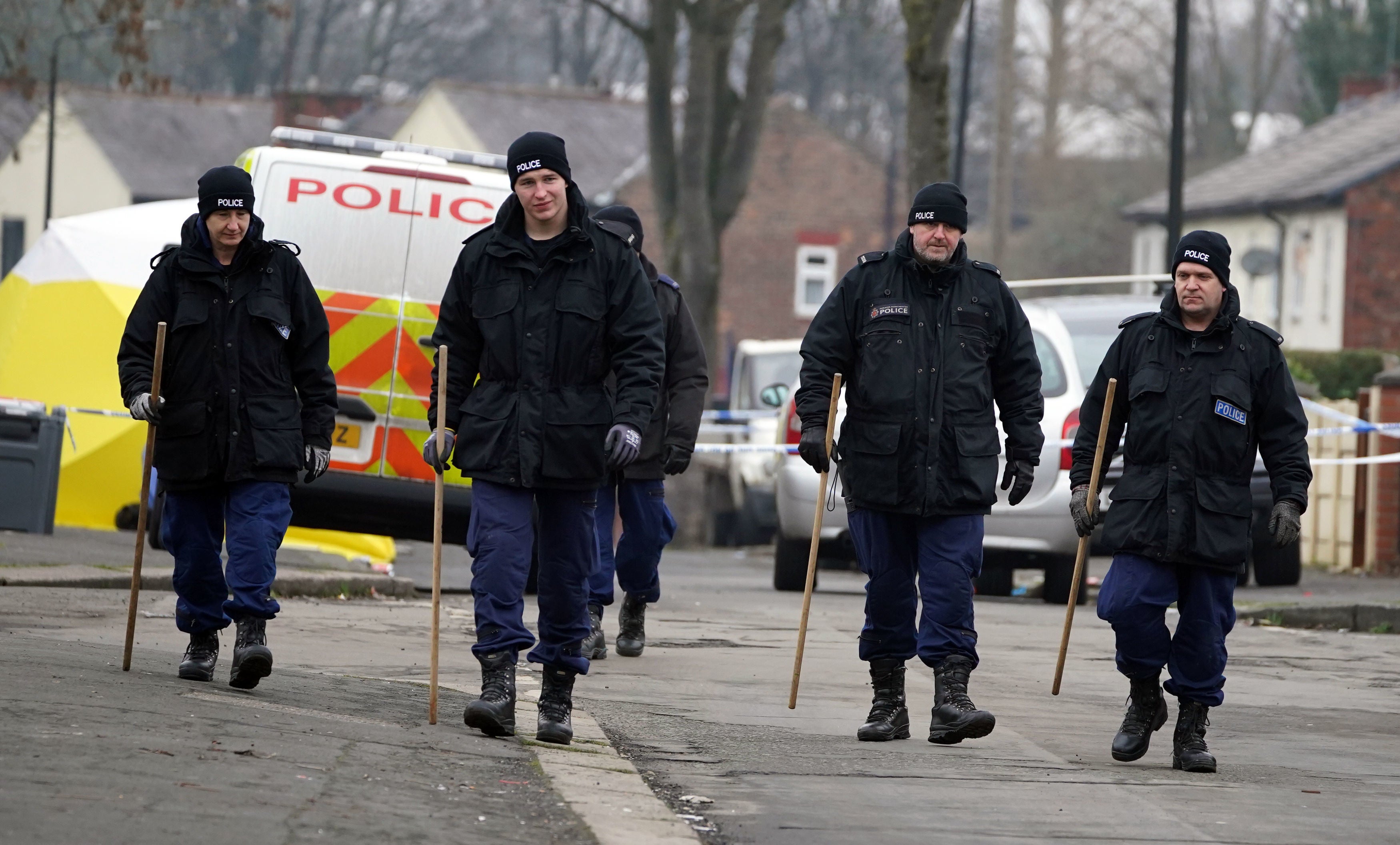 Greater Manchester Police officers searching for evidence at the scene on Thirlmere Avenue