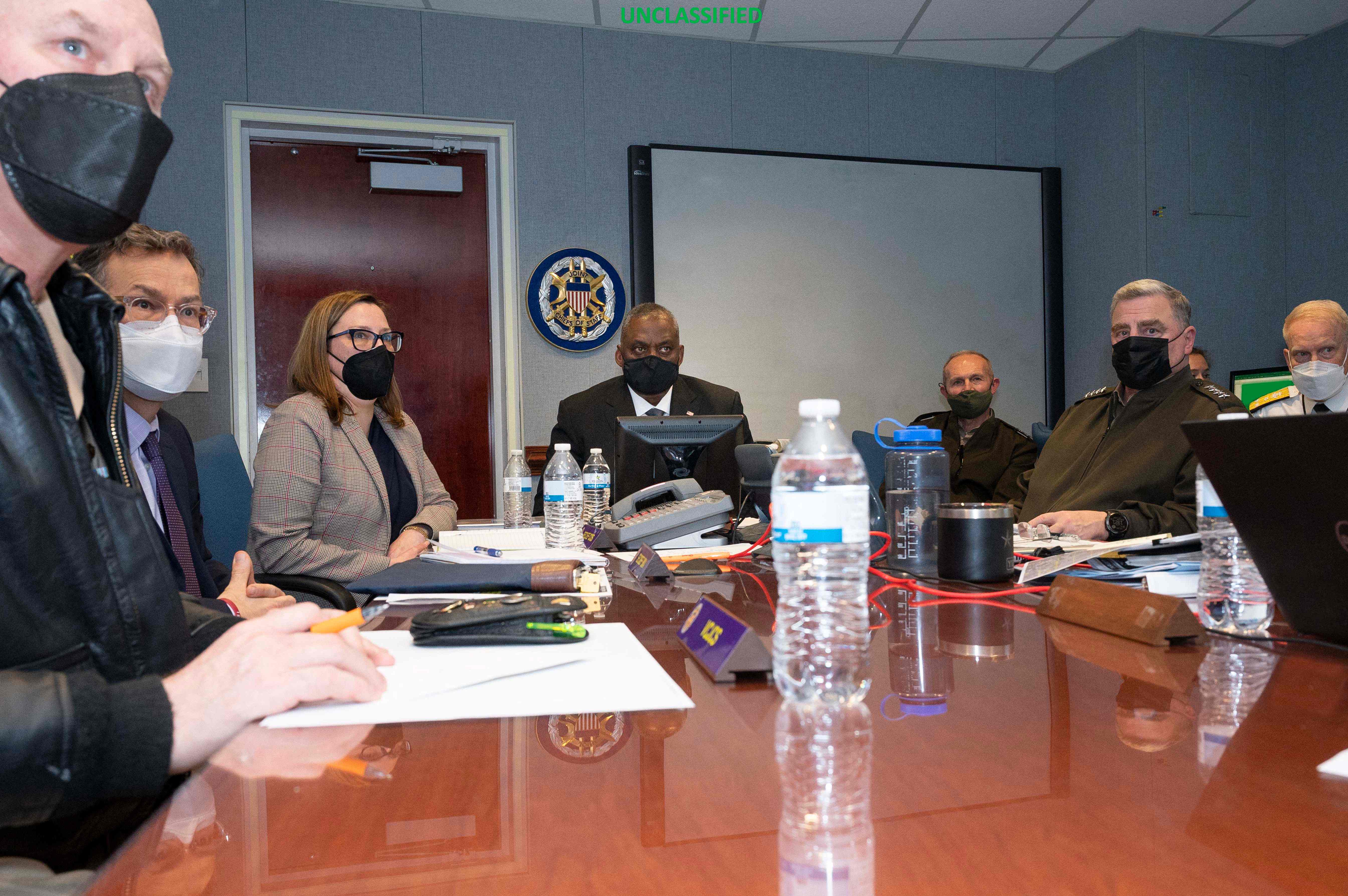 US Secretary of Defense Lloyd Austin (C) and Chairman of the Joint Chiefs of Staff Gen. Mark Milley (R) monitor the military operation in Syria from the National Military Command Center in Washington, DC