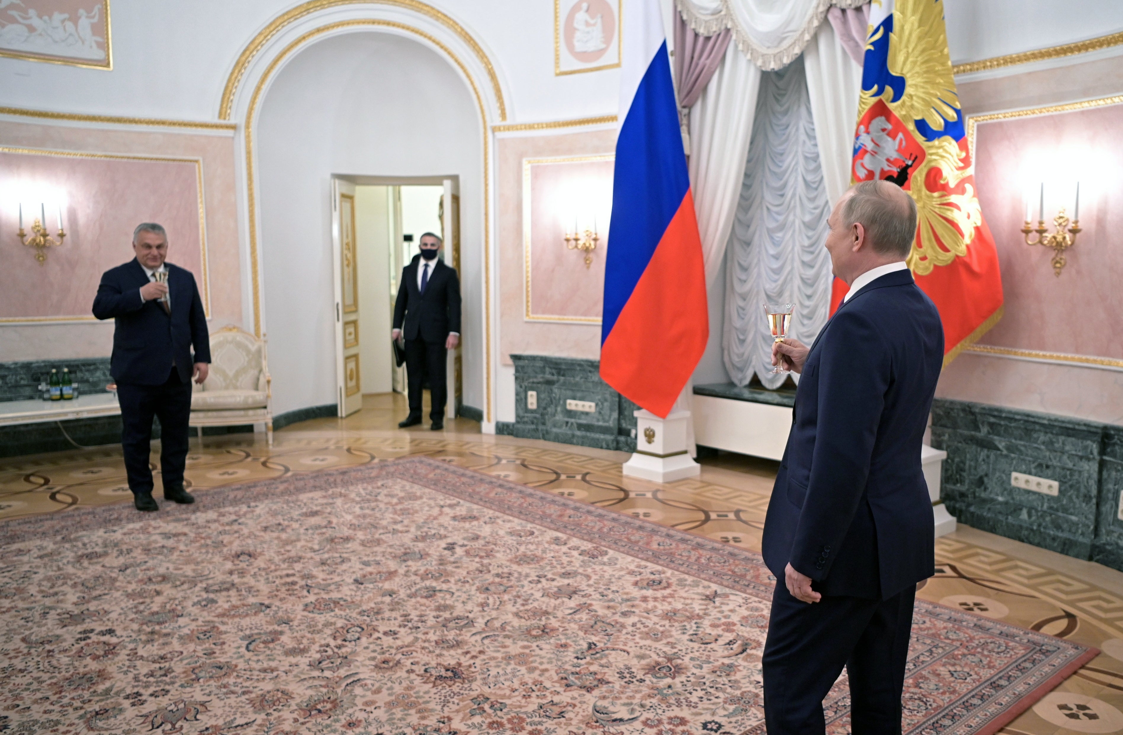 Russian president Vladimir Putin (R) raises a glass with Hungarian prime minister Viktor Orban (L) after their press conference during a meeting in the Kremlin on Tuesday