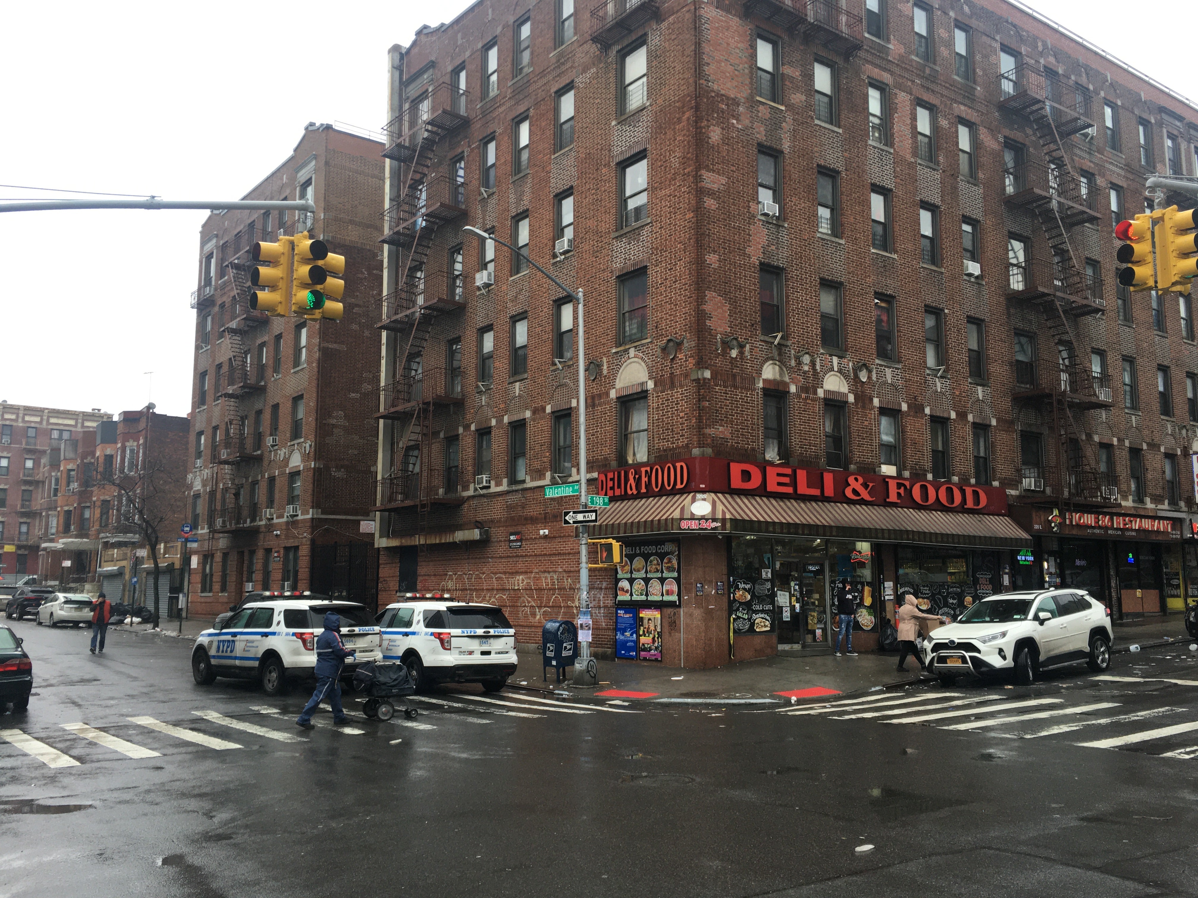 Police cruisers keep watch on the corner of East 198th St and Valentine Avenue where Catherine Ortiz was shot last month