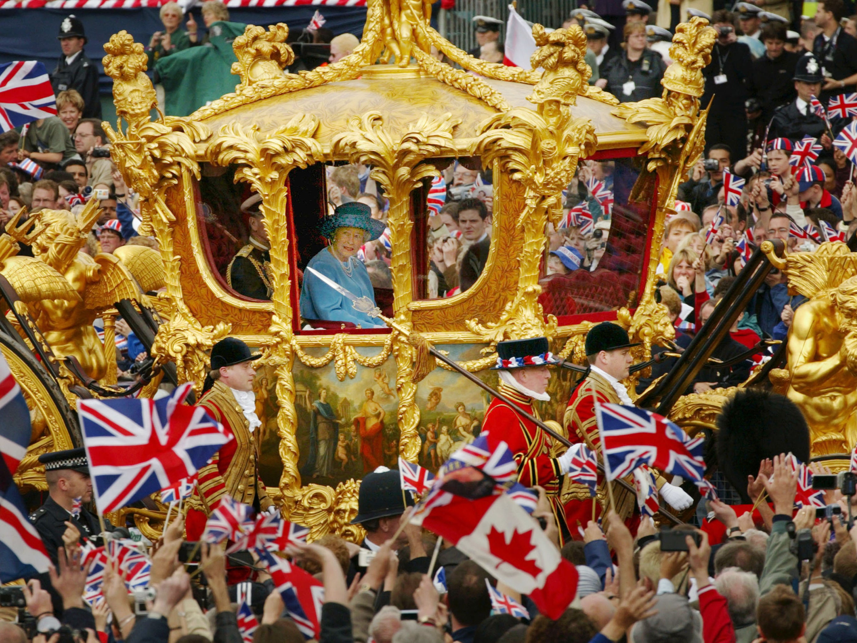 Queen Elizabeth and Prince Philip ride in the Golden State Carriage at the head of a parade from Buckingham Palace to St Paul's Cathedral celebrating the Queen's Golden Jubilee