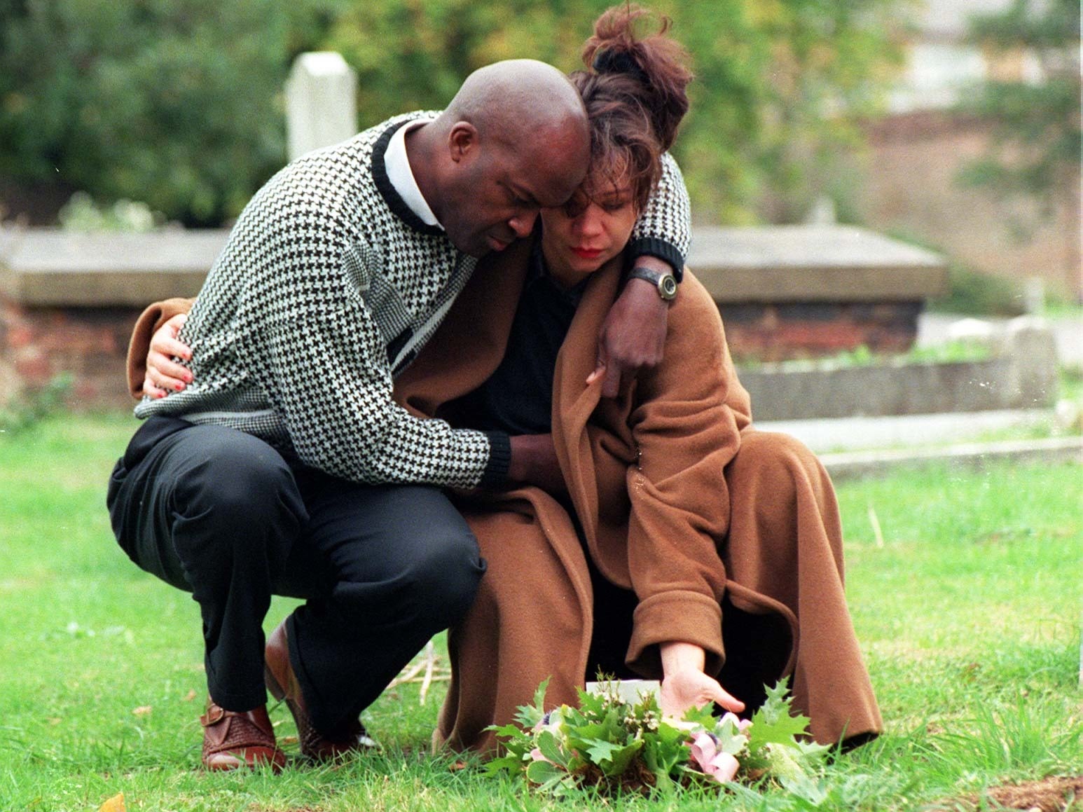 Mandy Allwood and boyfriend Paul Hudson visit the grave of their eight babies on the first anniversary of the funeral in October 1997