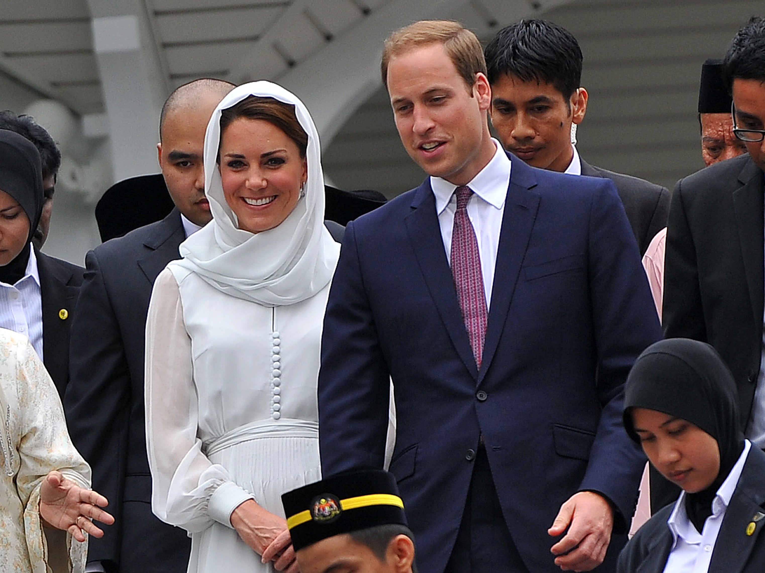 Prince William (centre R) and his wife Catherine, the Duchess of Cambridge (centre L) visit a mosque at KLCC in Kuala Lumpur on September 14, 2012