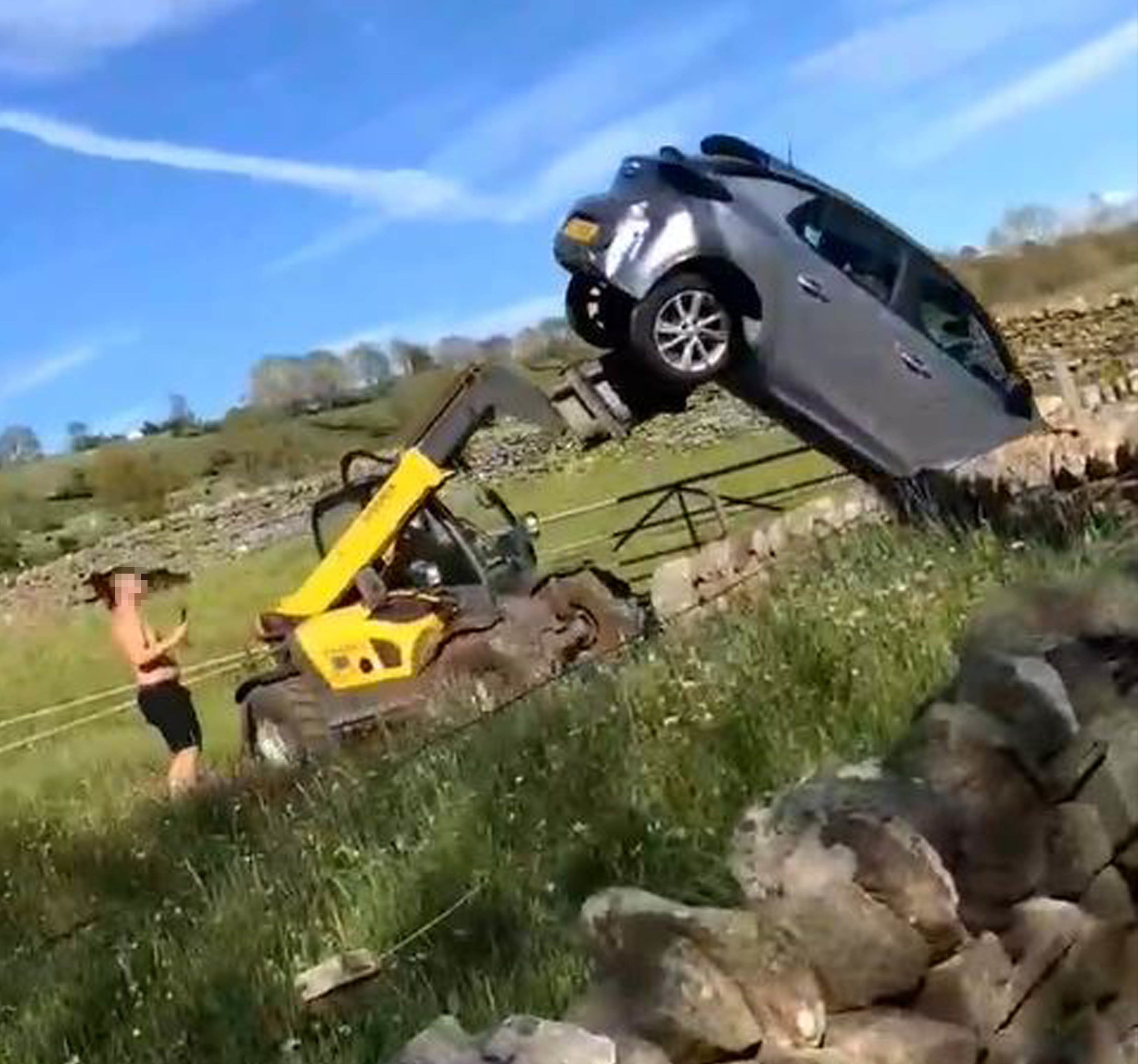 Still from video played at Durham Crown Court showing Charlie Burns (left) remonstrating with farmer Robert Hooper, who used a farm vehicle to remove a Vauxhall Corsa from his land