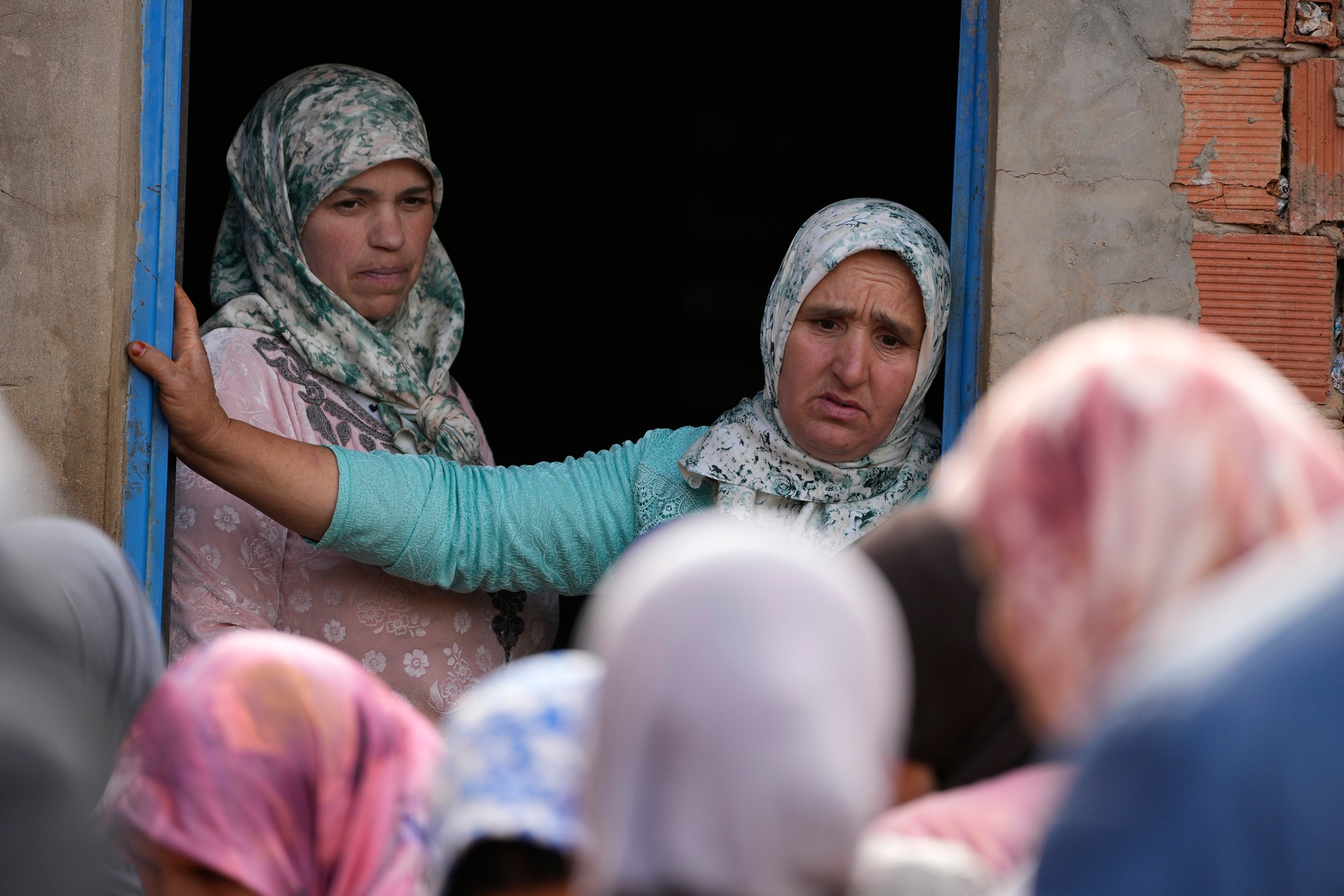 A woman reacts as civil defense workers and local authorities attempt to rescue Rayan