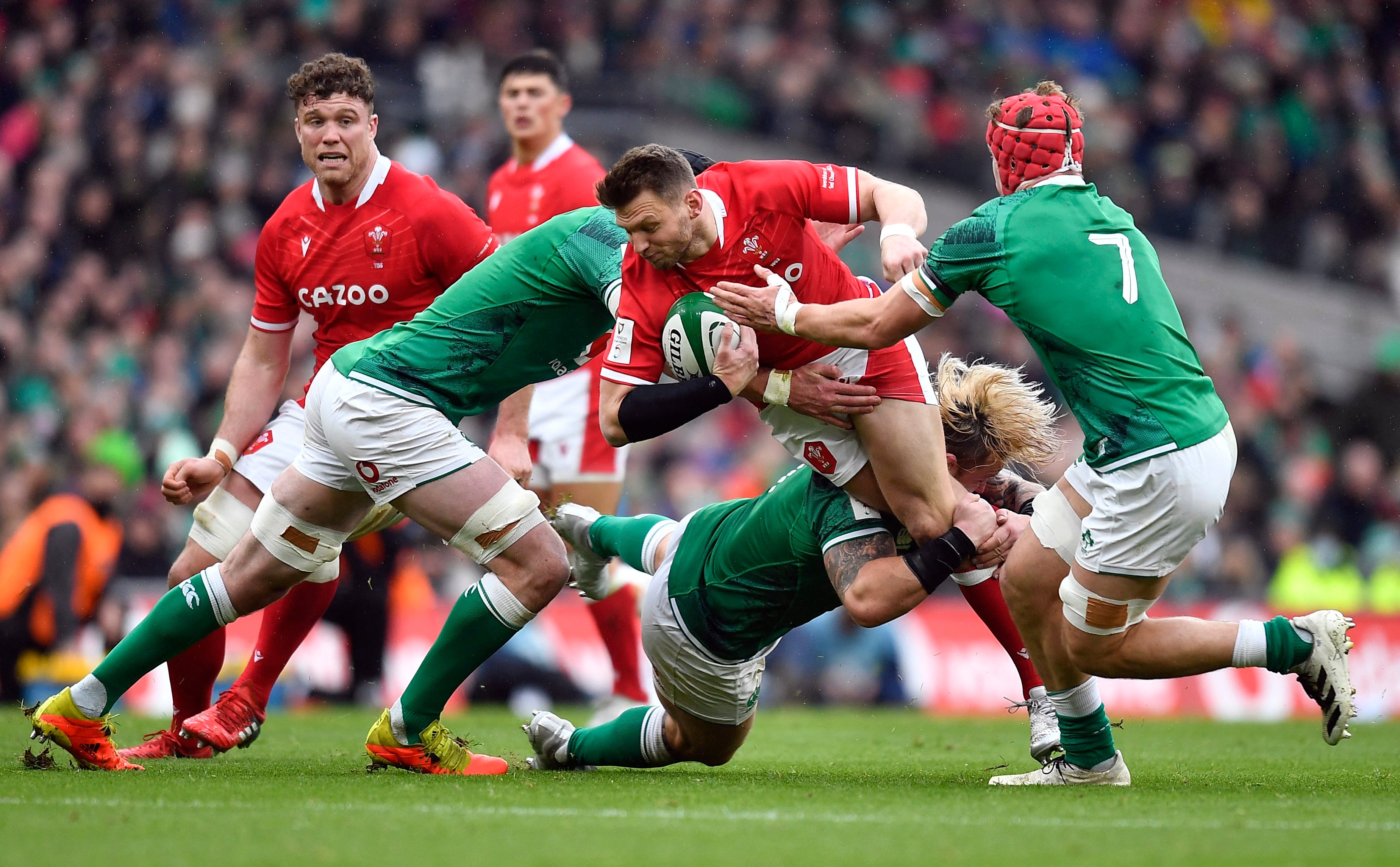 Wales’ Dan Biggar is tackled by three Irish defenders