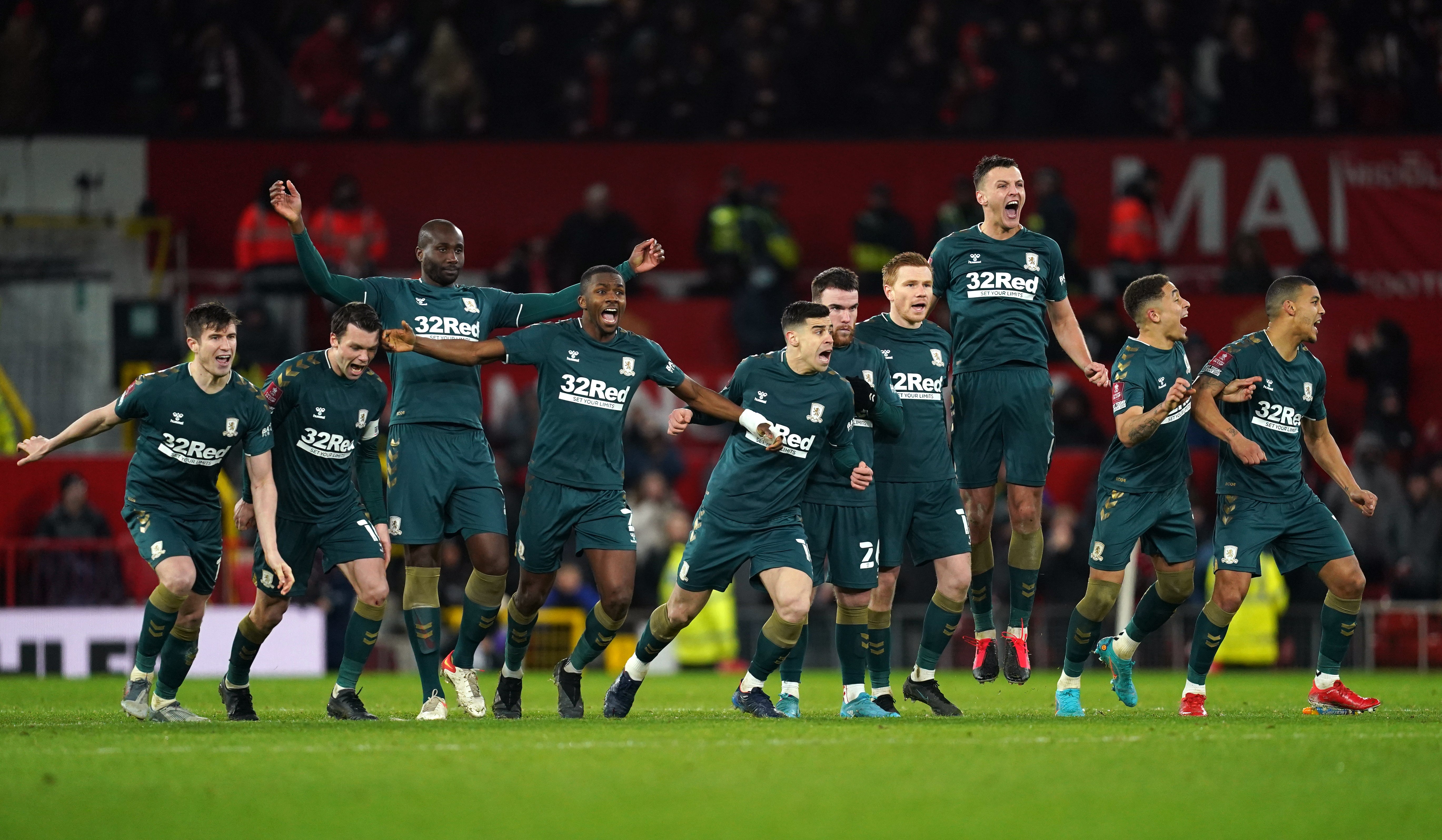 Middlesbrough players celebrate winning the penalty shoot-out after the Emirates FA Cup fourth round match at Old Trafford (PA)