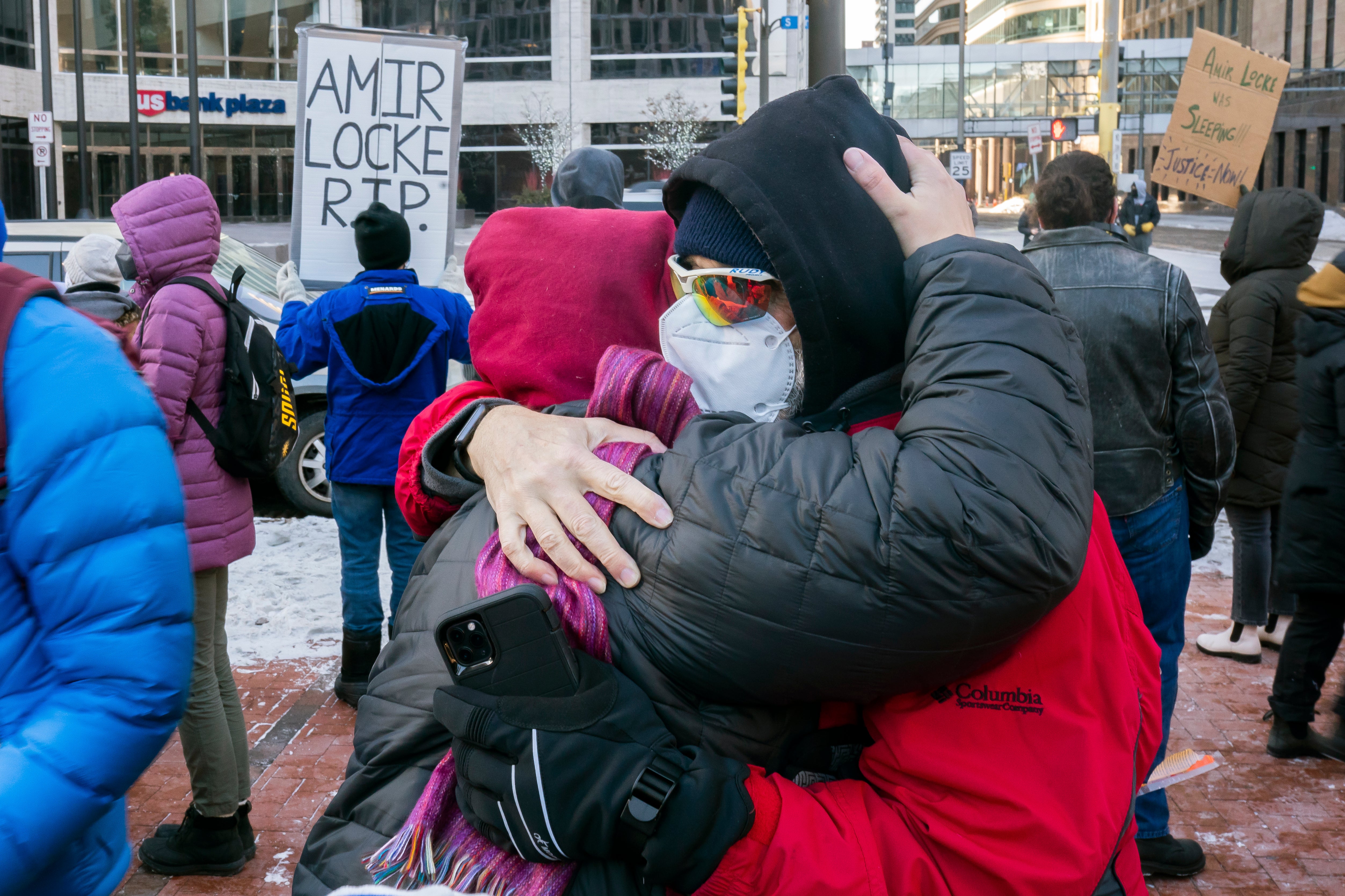 Two protesters embrace at a racial justice rally for Amir Locke on February 5, 2022 in Minneapolis, Minnesota