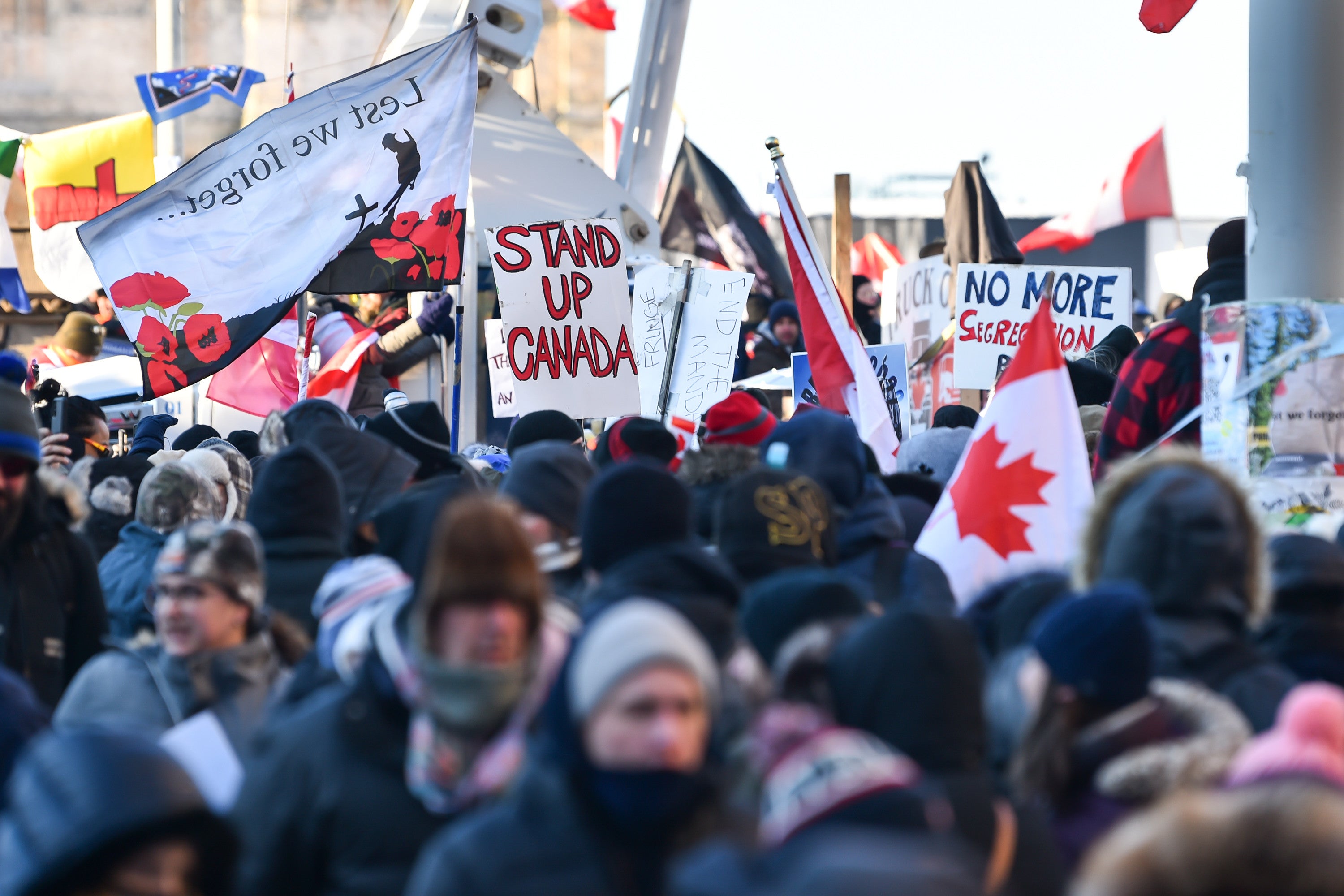 Thousands of protesters gathered near Parliament Hill in Ottawa on Saturday holding signs condemning the vaccine mandates