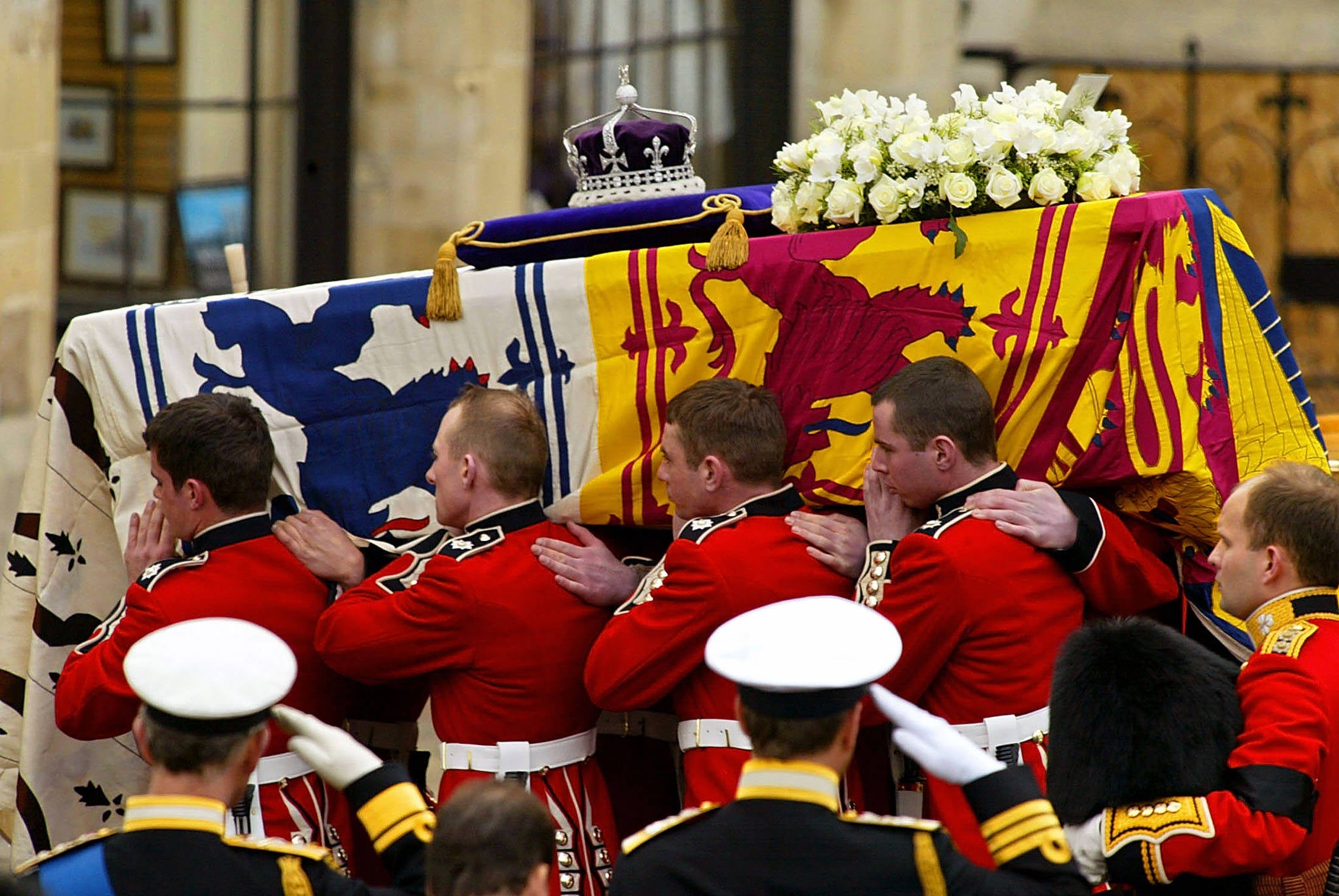 Pall Bearers carry the coffin of Queen Elizabeth, the Queen Mother from the gun carriage on which it travelled from Westminster Hall to Westminster Abbey in London for the funeral service