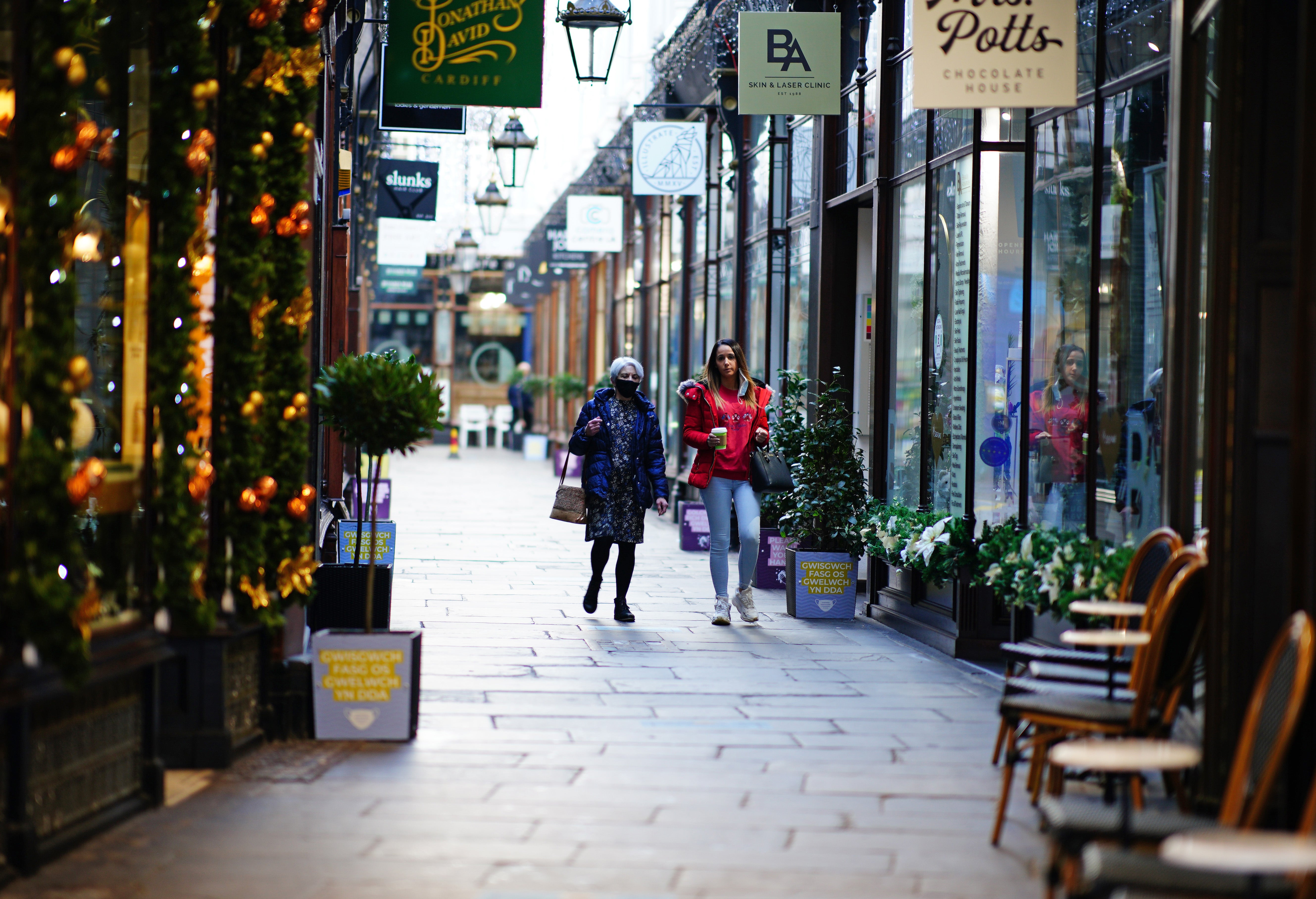 Two women walk through a shopping arcade in the centre of Cardiff, Wales. retail sales rebounded in January according to new figures (Ben Birchall/PA)