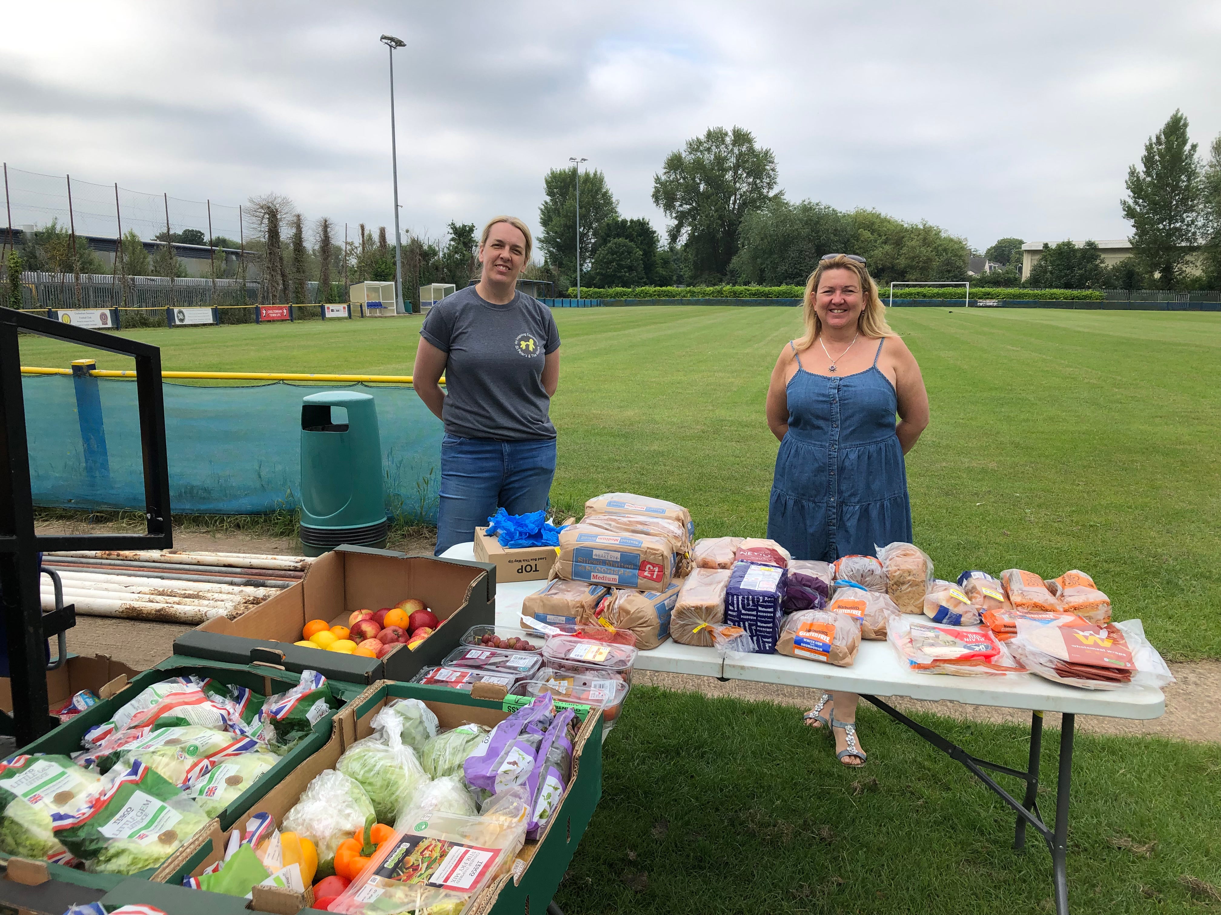 Patterson (right) collects food from the supermarkets at the end of the day and hands it out for free