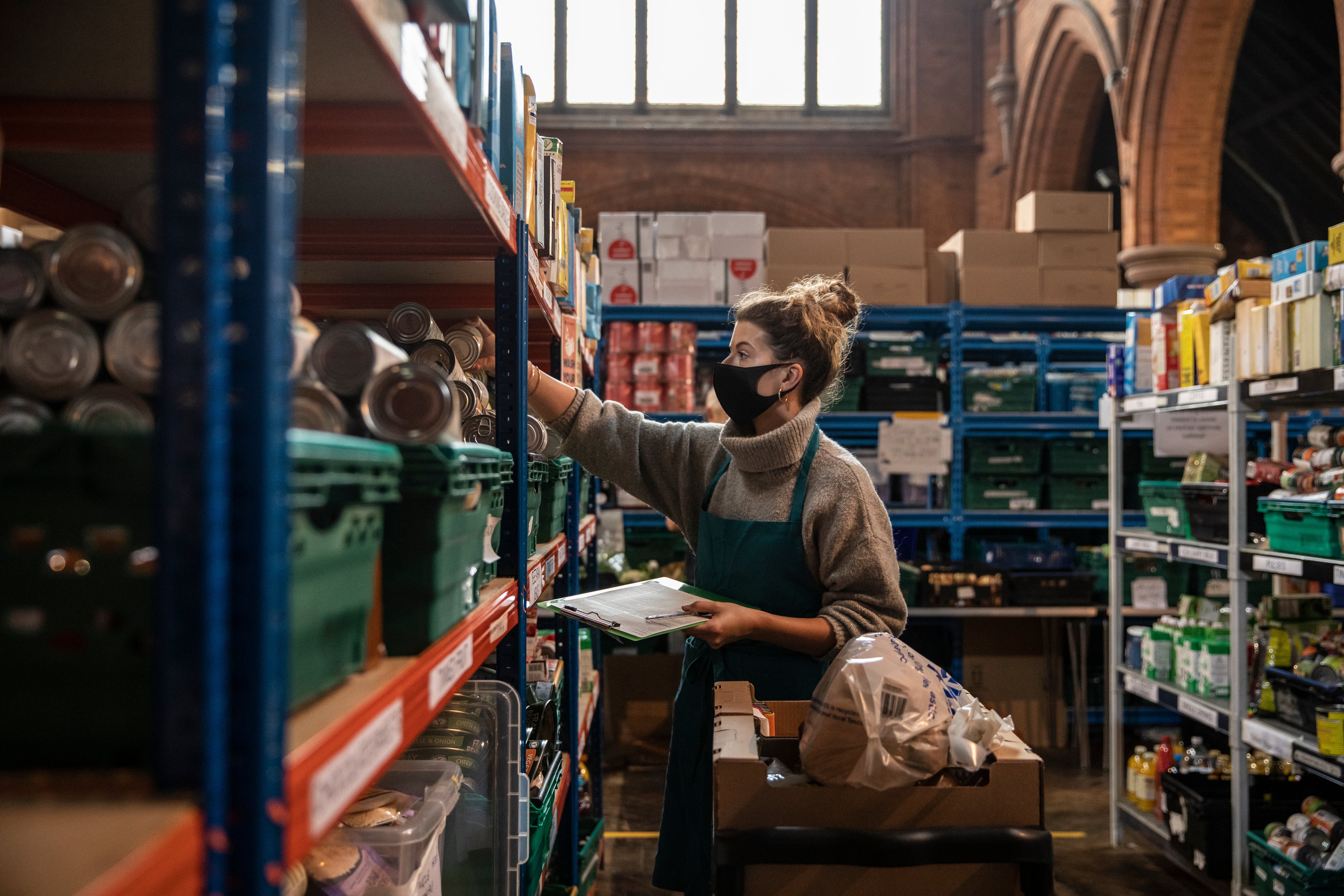 Staff and volunteers pack and prepare food parcels at the south London warehouse and distribution centre at St Margaret’s Church in London