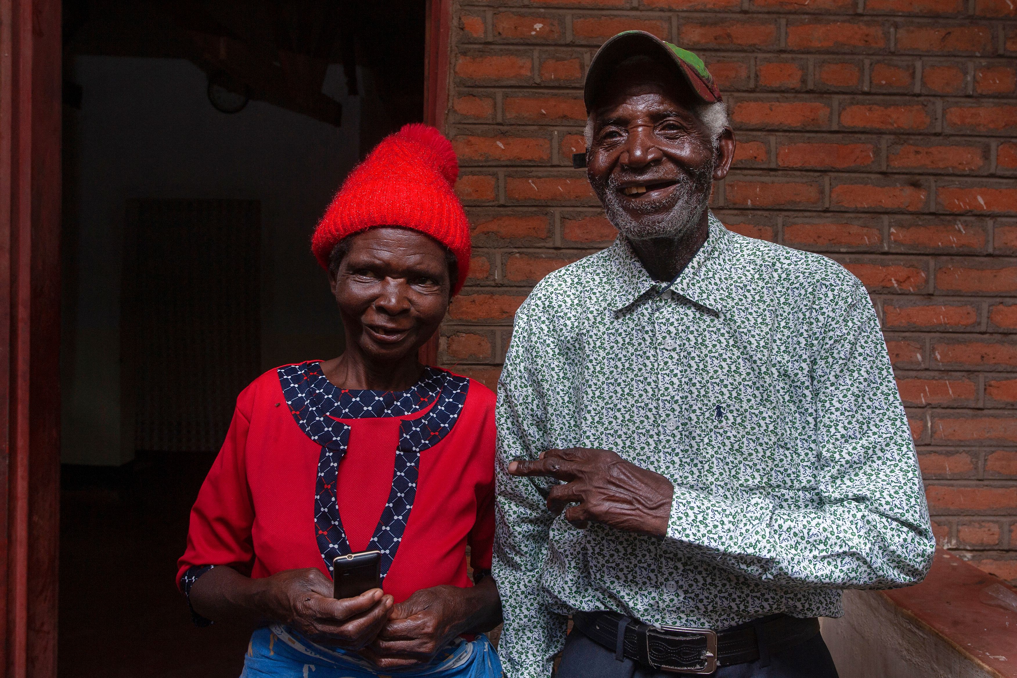 Malawian musician Giddes Chalamanda (R), 92, poses with his wife Margalita Alfred, 71, at their home in Madzuwa Village