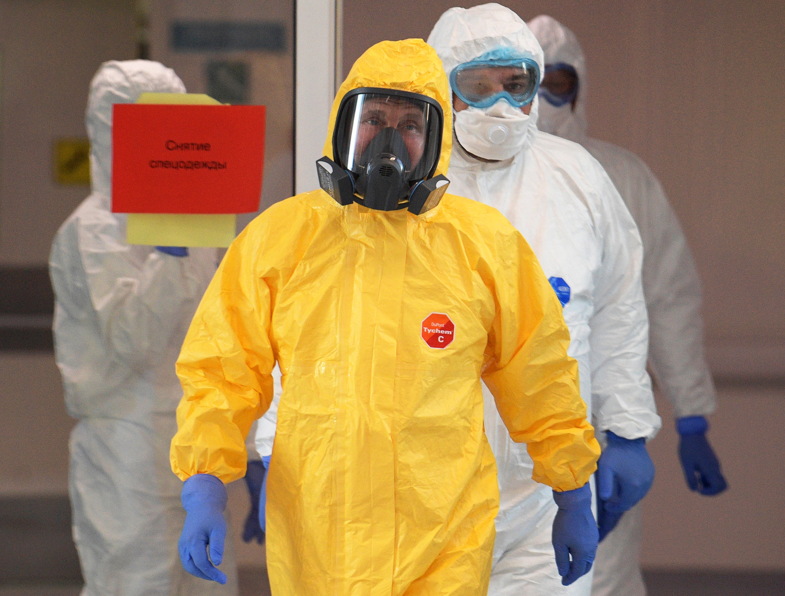 Putin wears a protective suit for a visit to a hospital in Moscow in March 2020