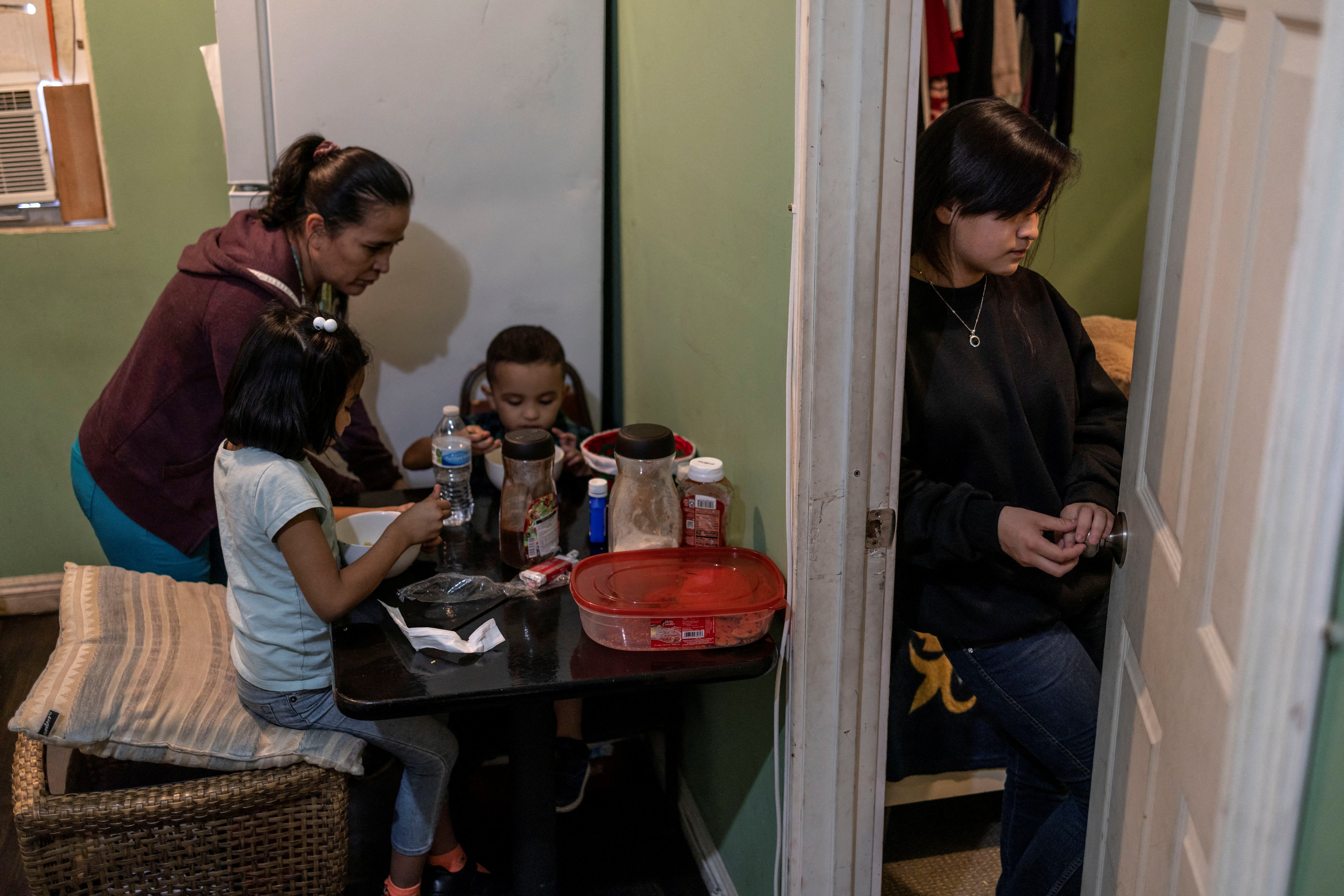 Maria serves dinner to Nicole and Aron as Michelle stands in the doorway