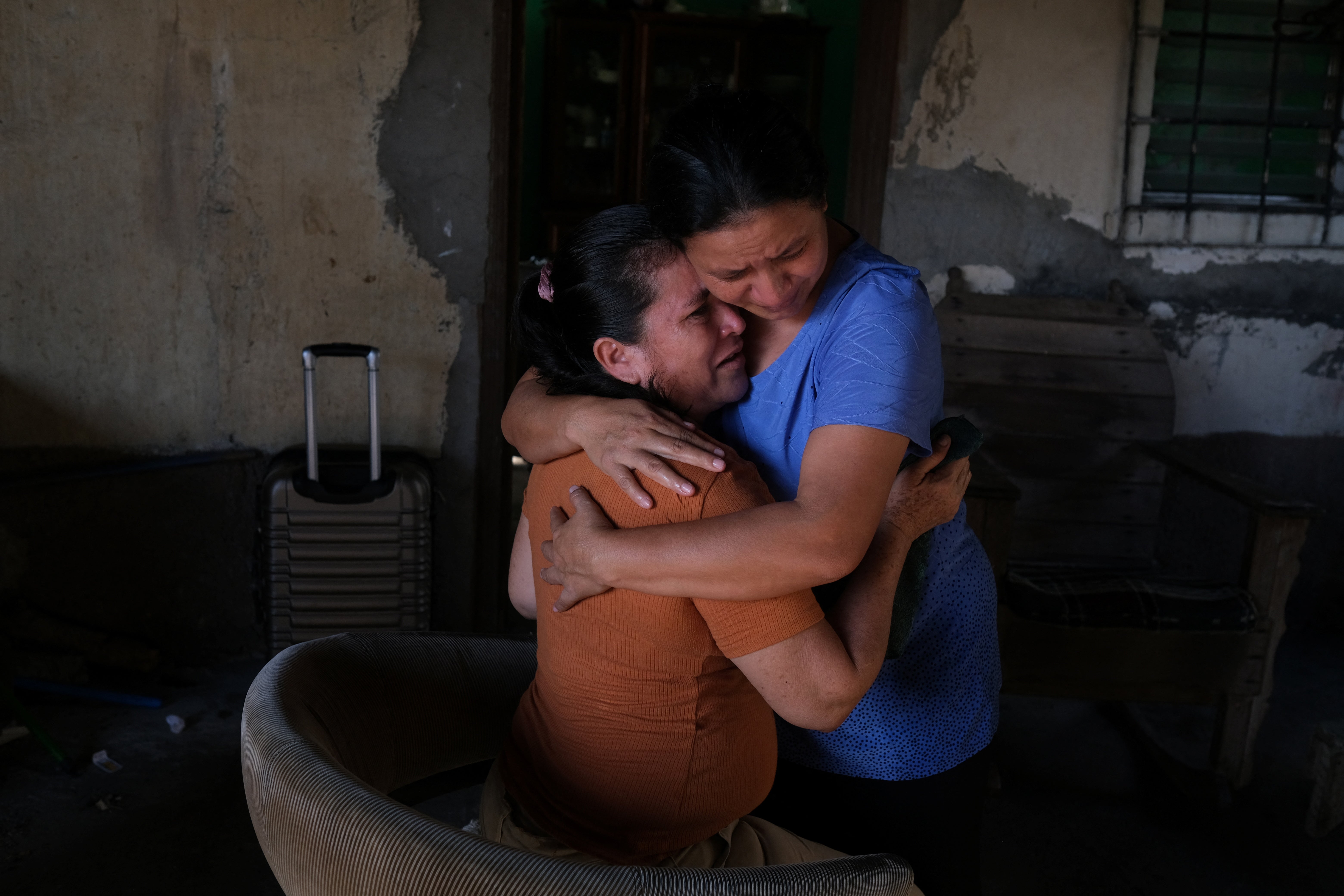 Maria embraces her friend as they say goodbye