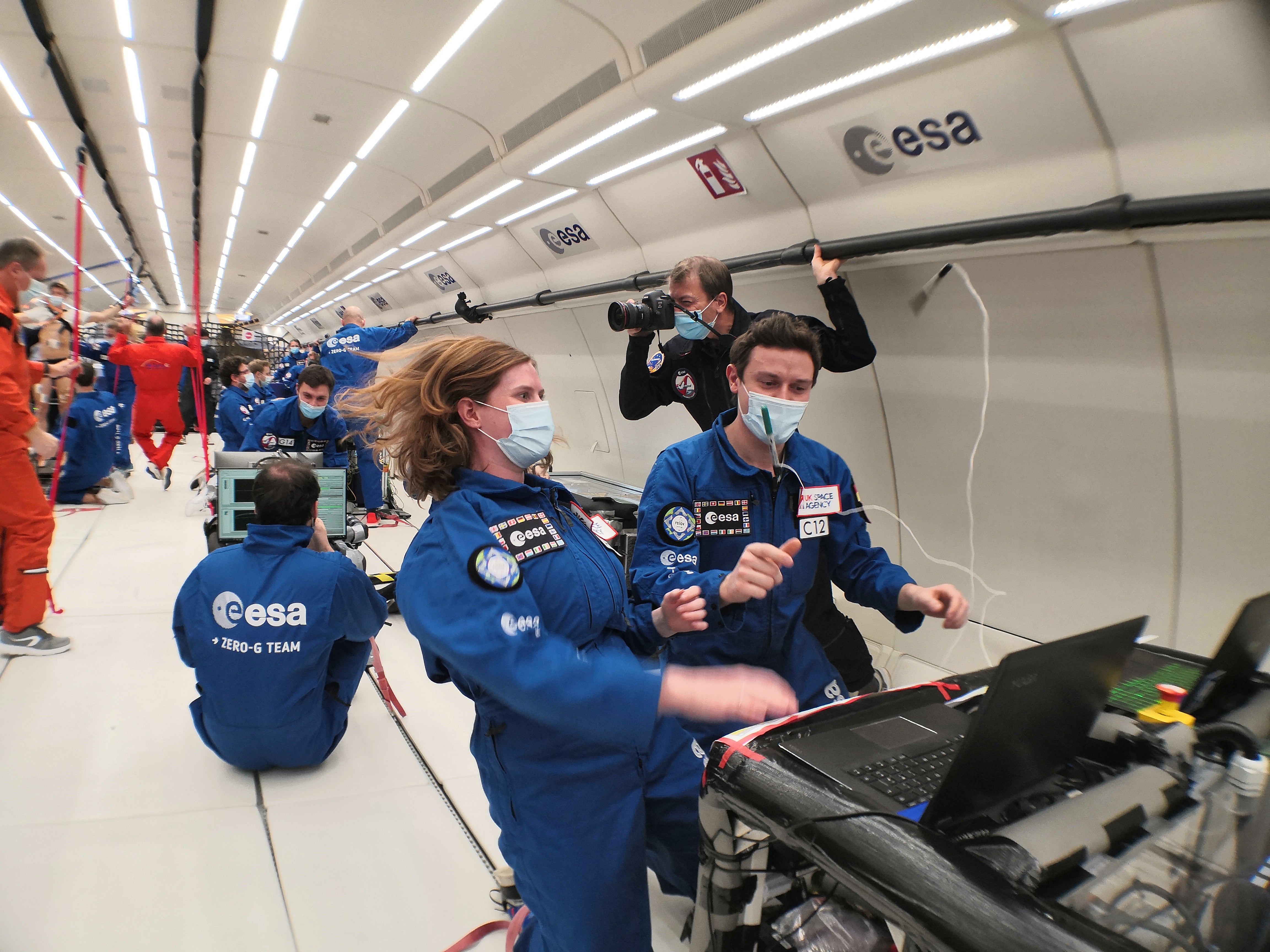 Dr. Beth Lomax and her ESA researach colleagues prepare an experiment for extracting oxygen from lunar soil aboard an aircraft in a steep dive to simulate microgravity conditions.