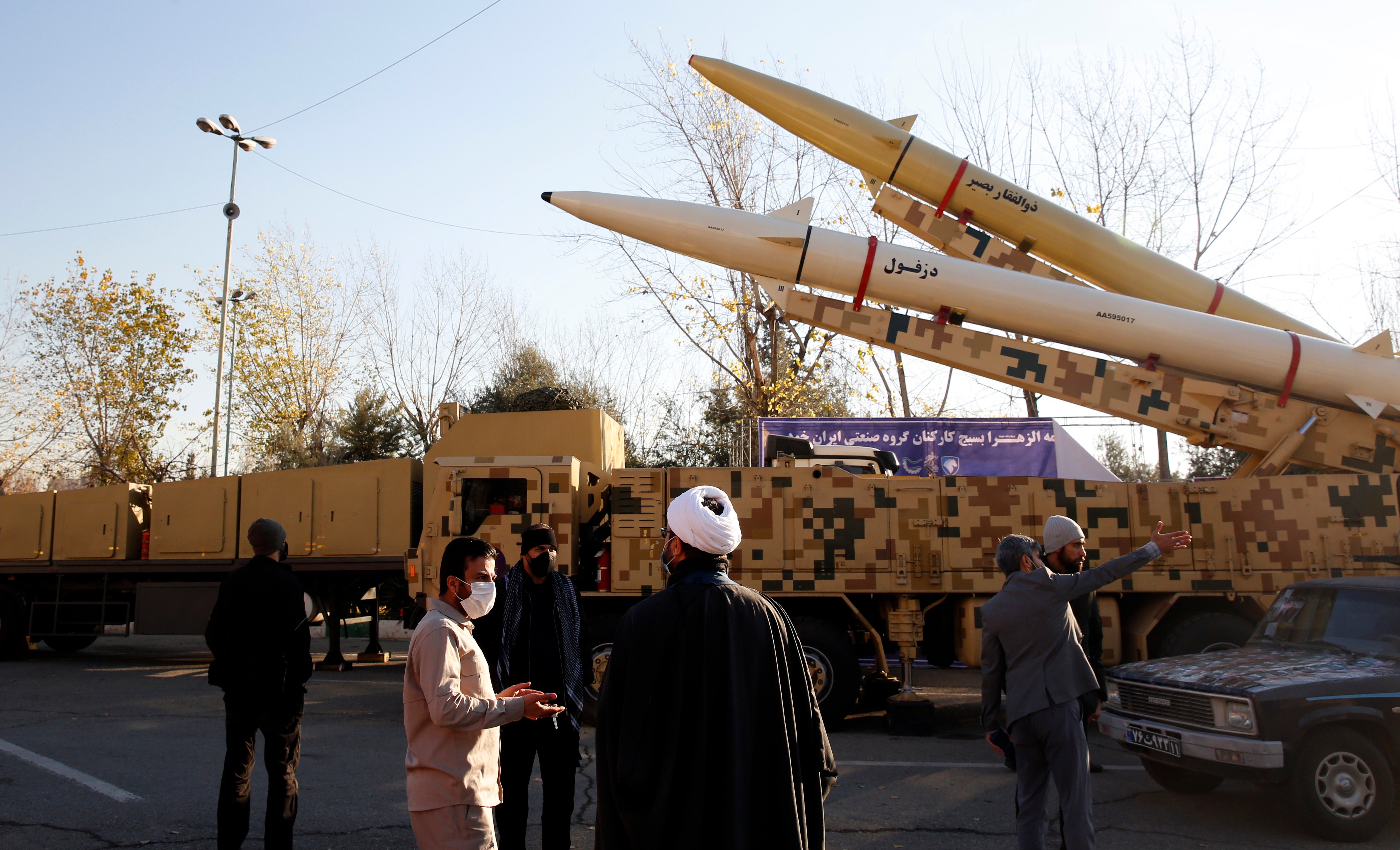 Iranian officials gather around missiles displayed at Mosallah Mosque in Tehran, Iran, 7 January 2022