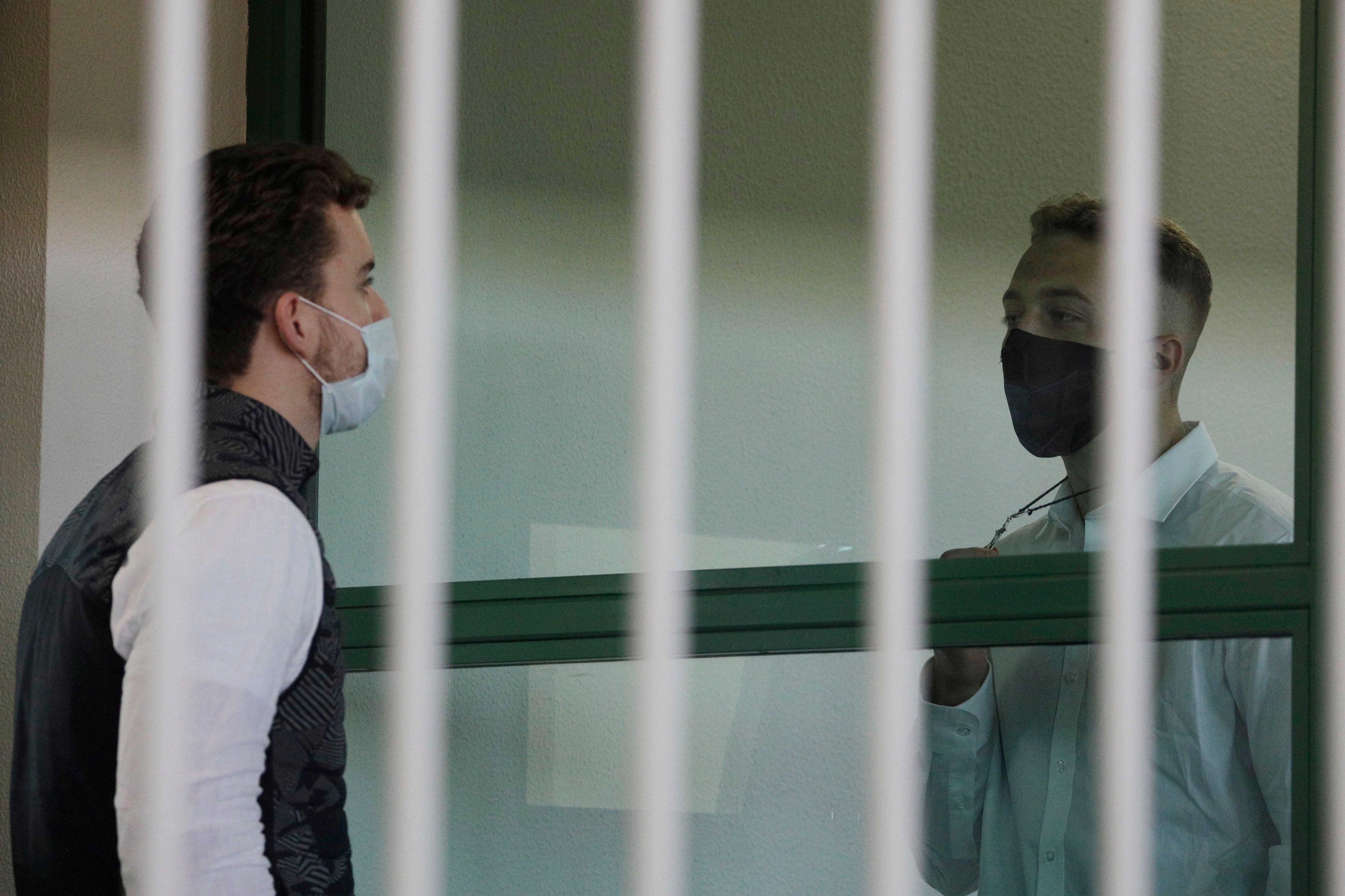 Gabriel Natale Hjorth shows his co-accused Finnegan Elder a crucifix during their murder trial in Italy last year