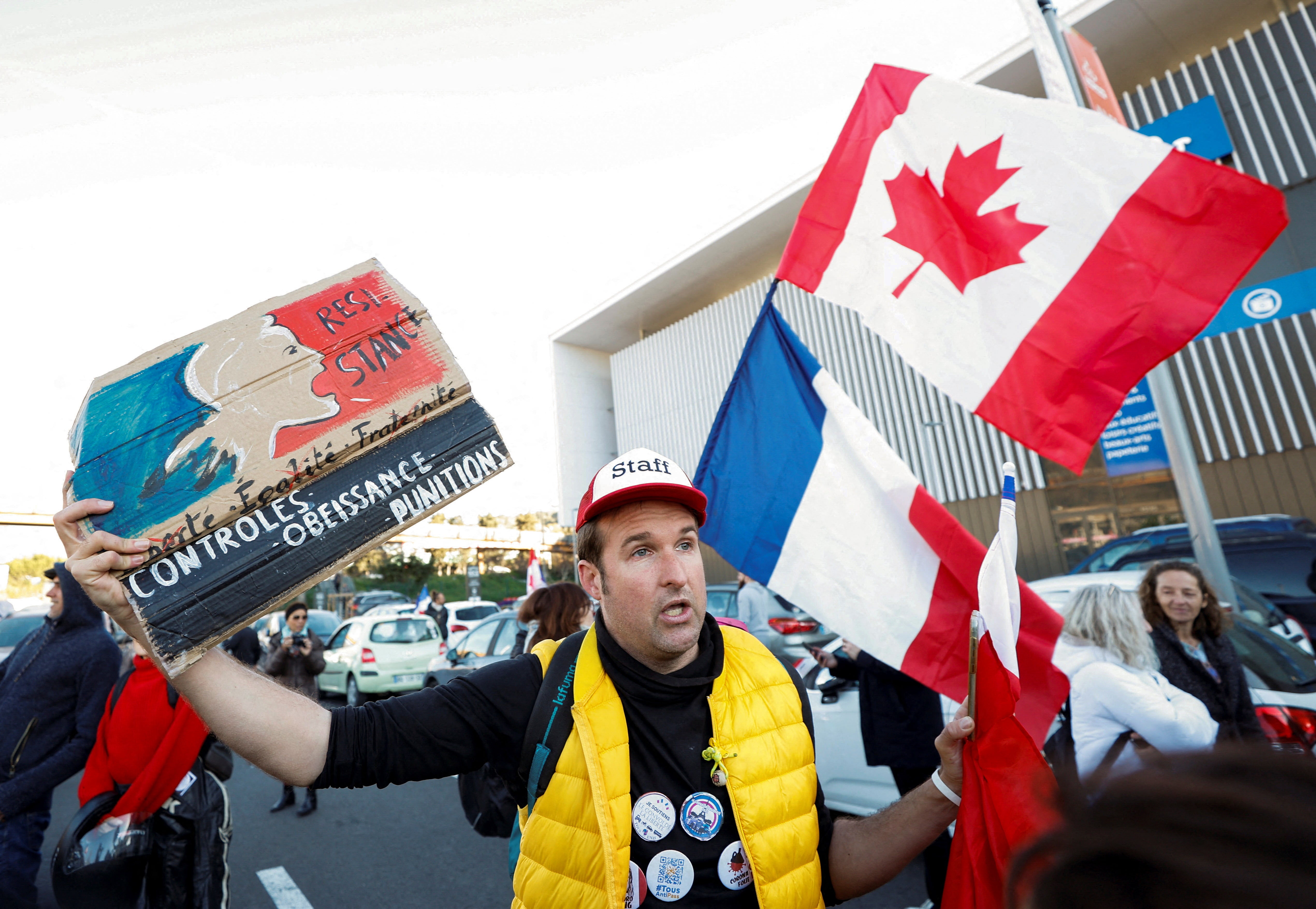 A French activist holds a poster reading “Resistance” before the start of their “Convoi de la liberte” (The Freedom Convoy) in Nice, France, 9 February 2022