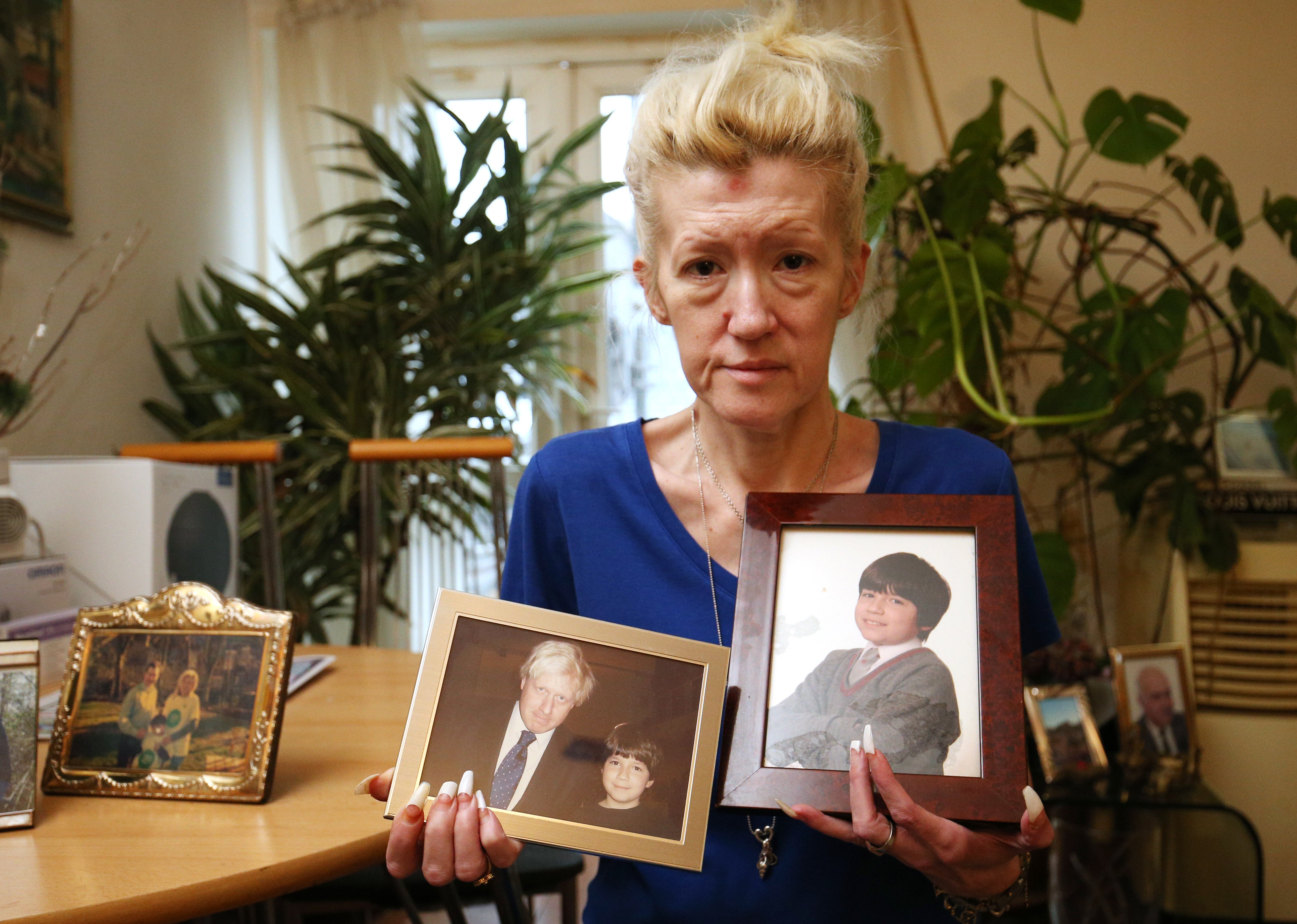 Jasna Badzak holding photographs of her son Sven