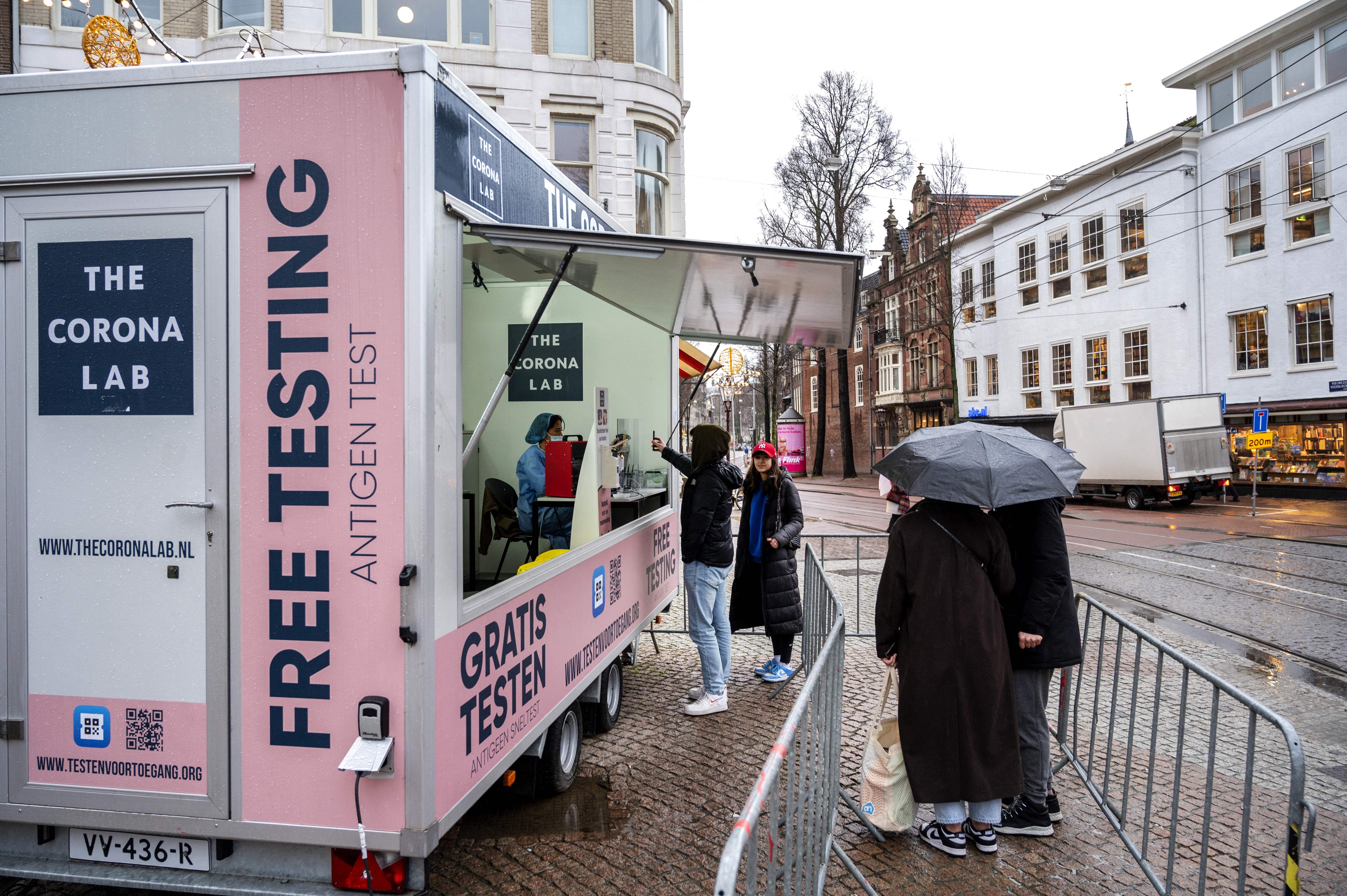 Local residents wait in line at a Covid-19 mobile testing unit in Amsterdam on 4 February 2022