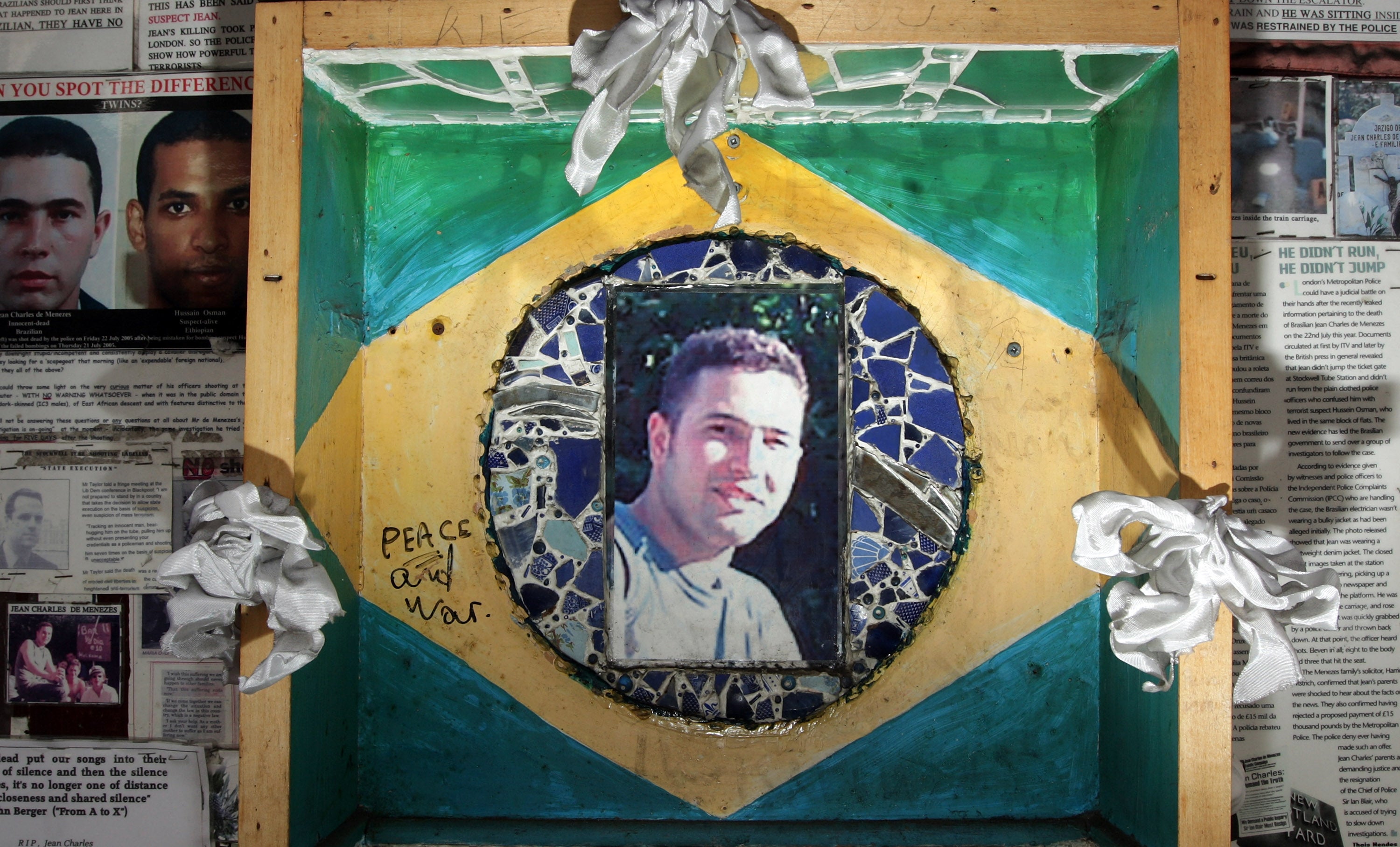 A memorial made up of press cuttings and photographs outside Stockwell Tube station to honour Jean Charles de Menezes