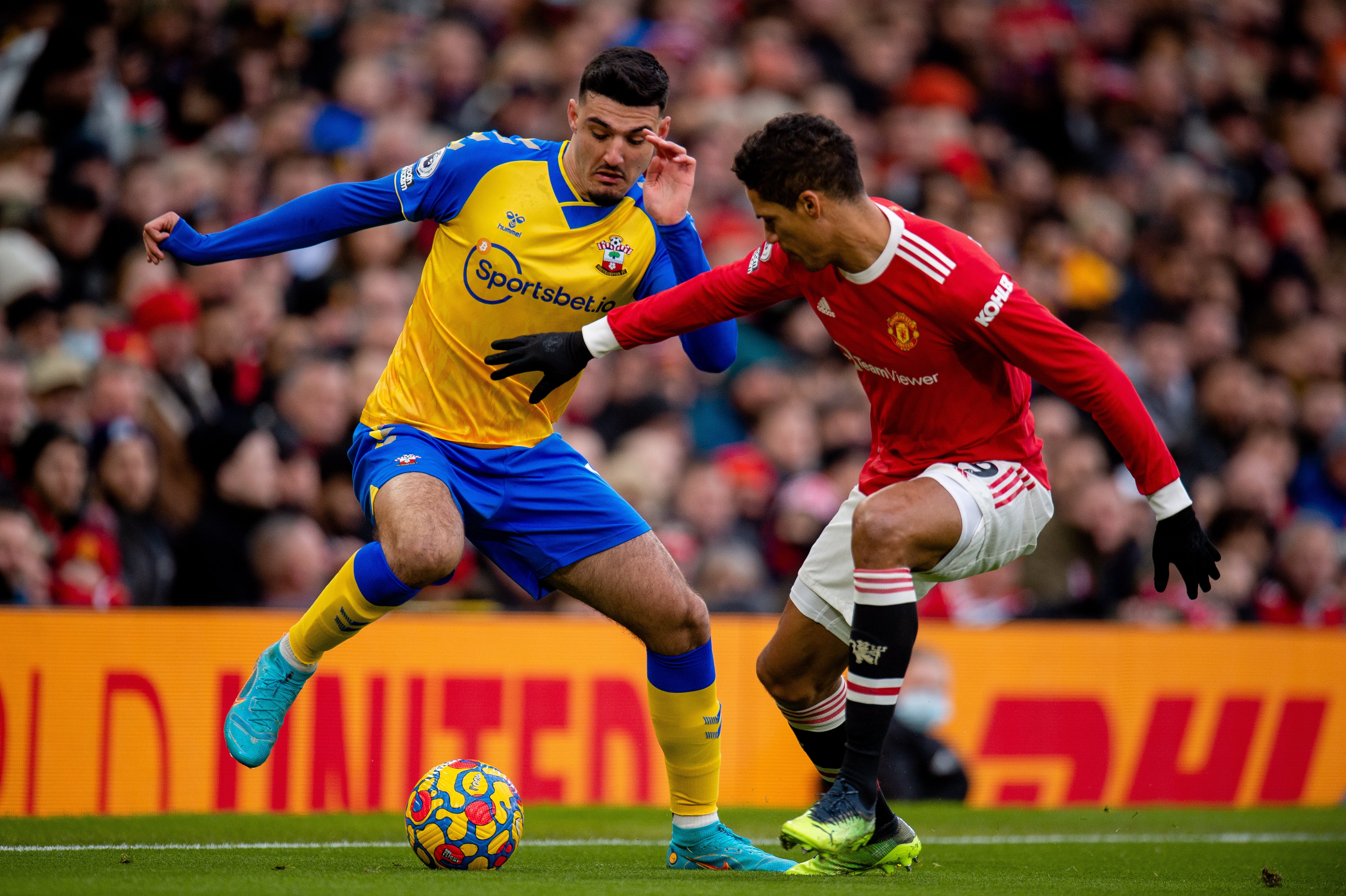 Armando Broja is held up by Raphael Varane