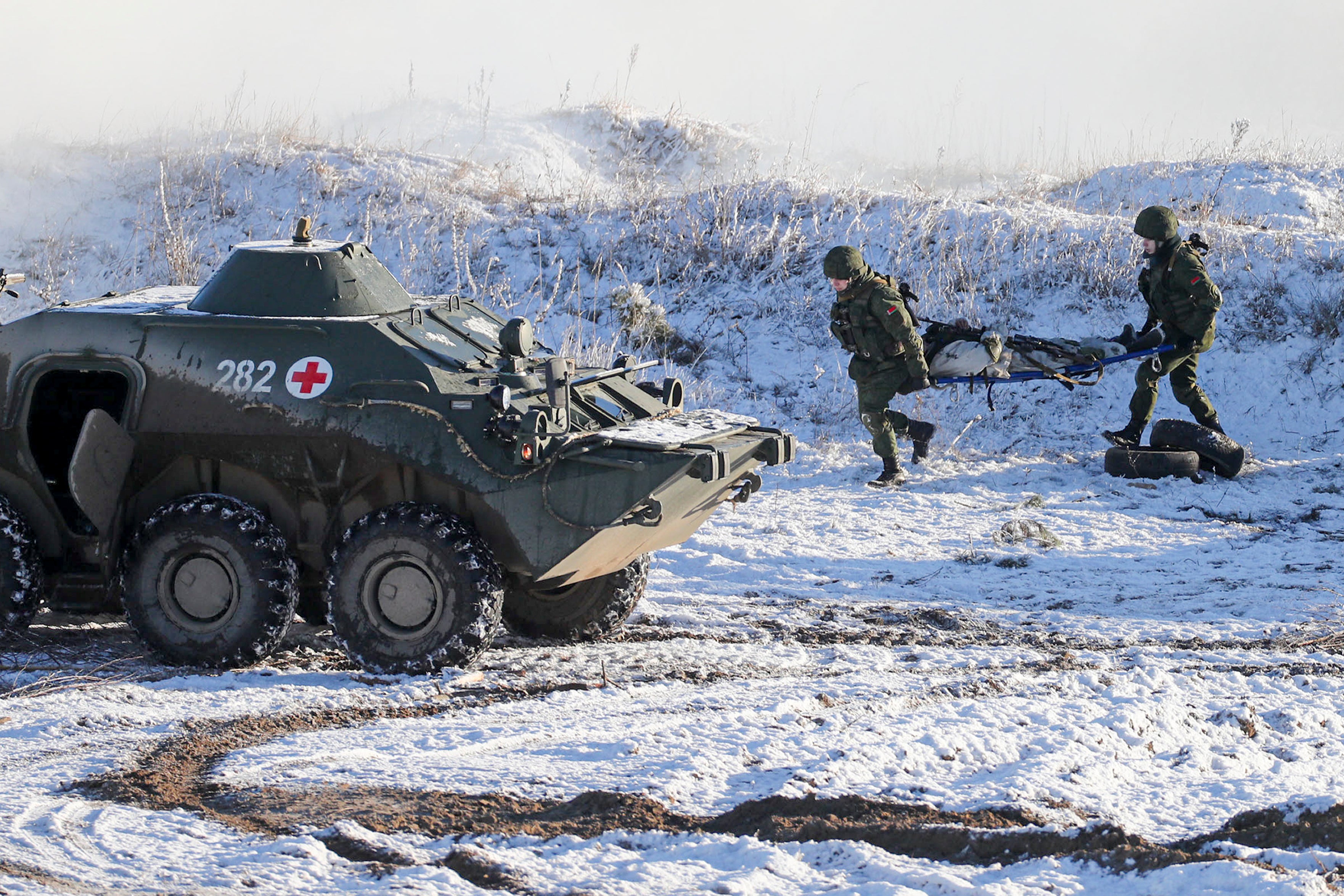 Soldiers carry a supposedly wounded comrade at the Gozhsky training ground during the Union Courage-2022 Russia-Belarus military drills in Belarus