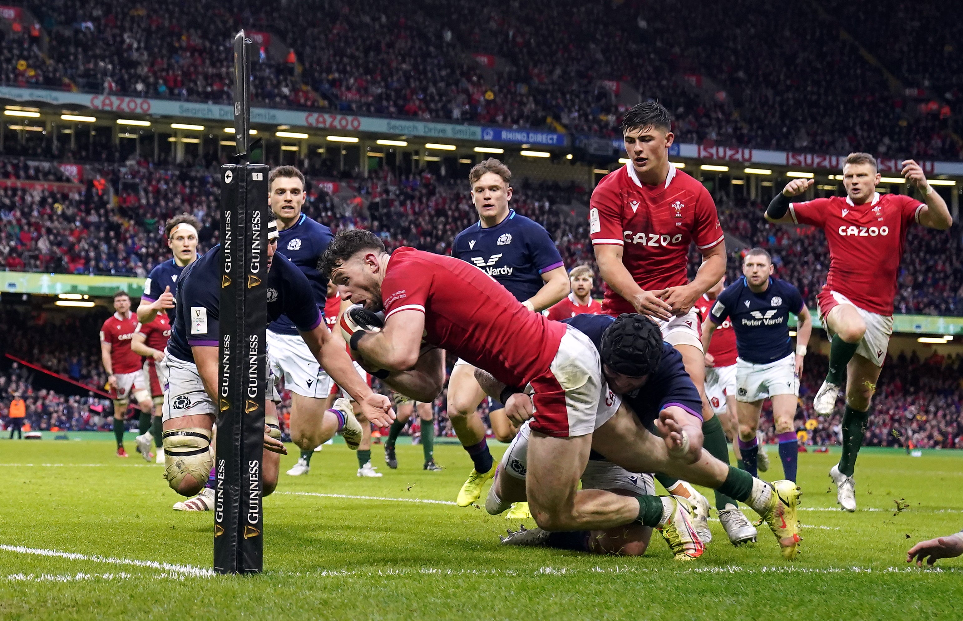 Wales wing Alex Cuthbert is prevented from touching down in the corner by Scottish defenders in Cardiff (David Davies/PA)