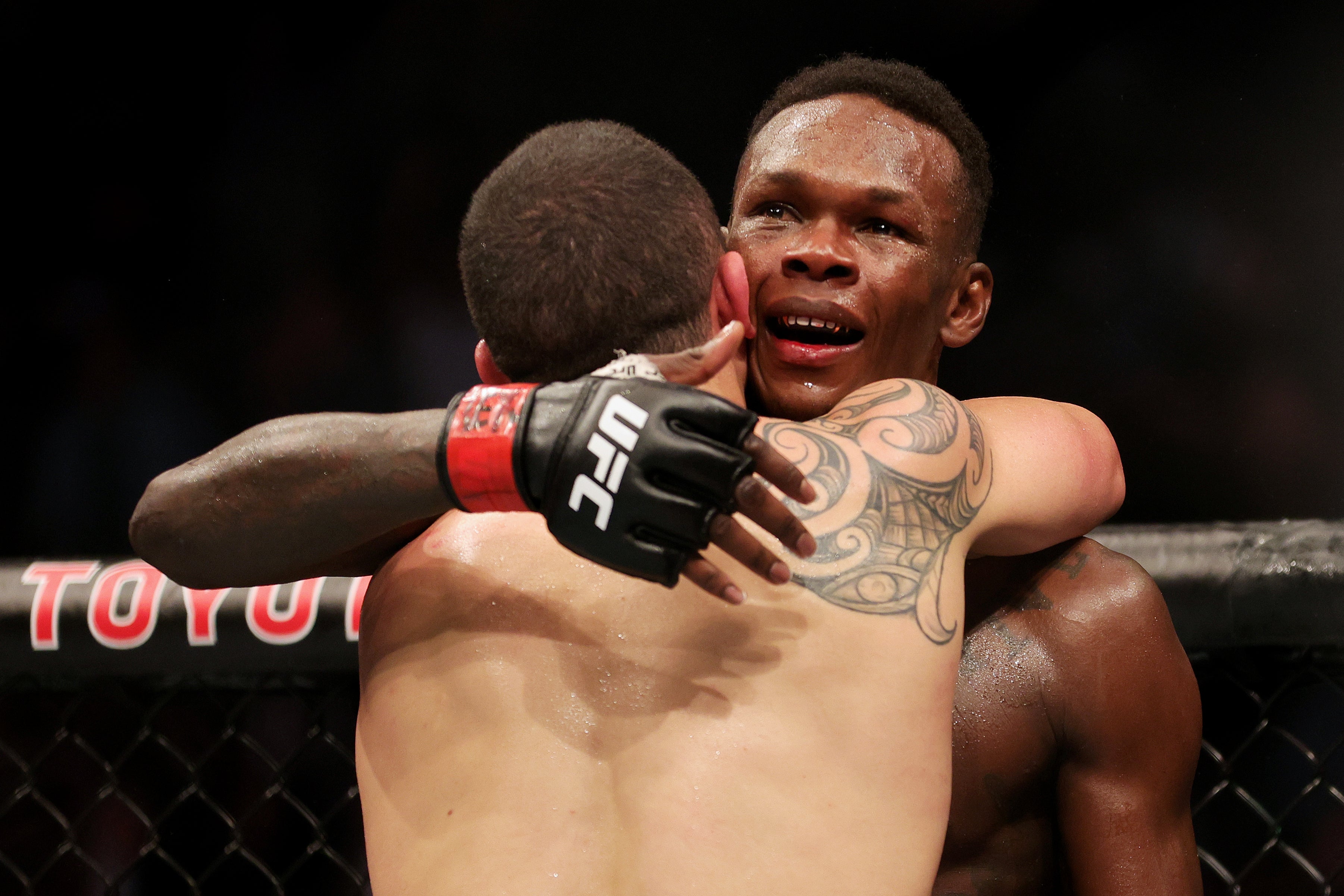 Adesanya and Whittaker embrace after their UFC 271 main event