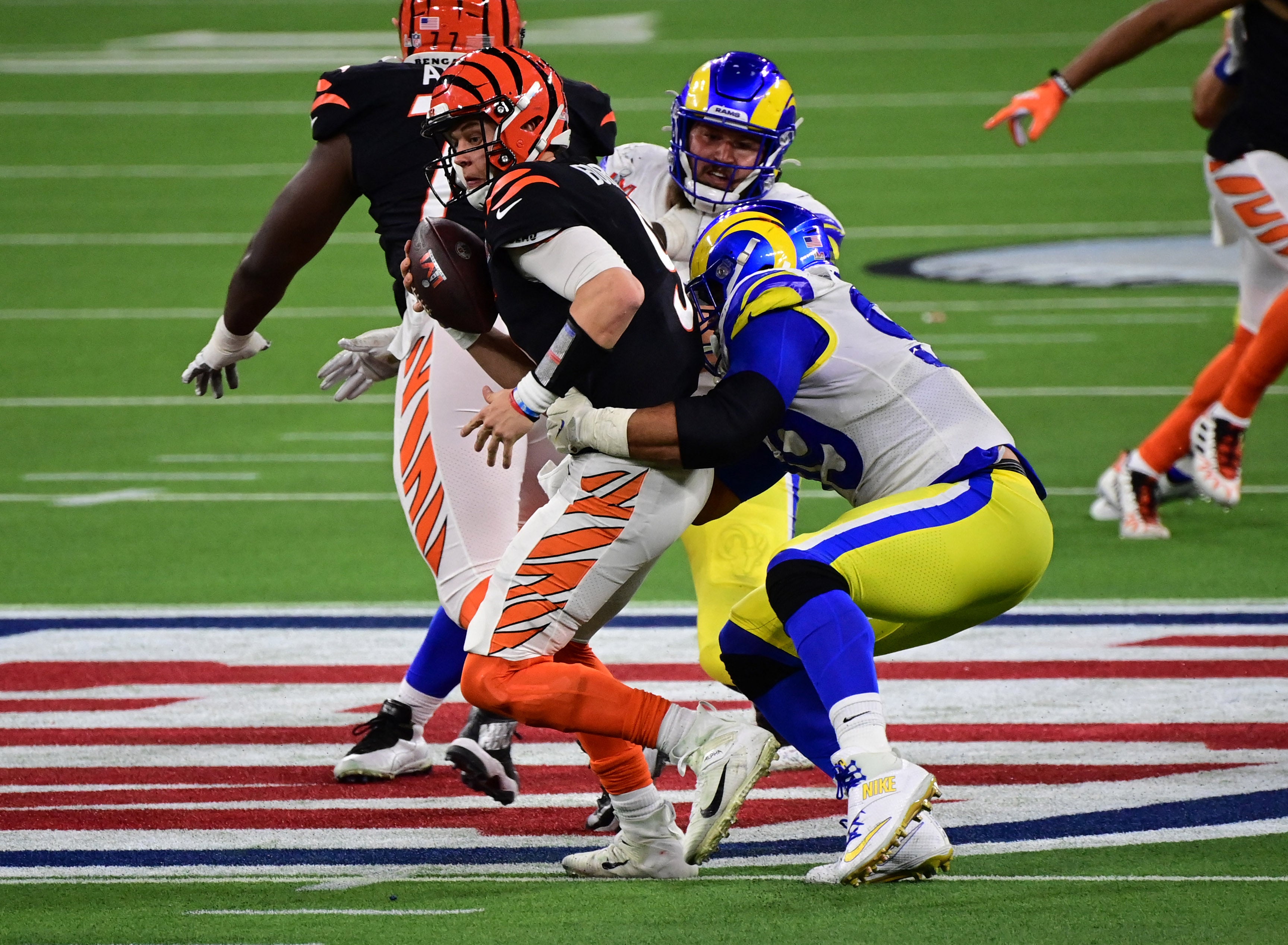 Los Angeles Rams defensive tackle Aaron Donald wraps up Cincinnati Bengals quarterback Joe Burrow