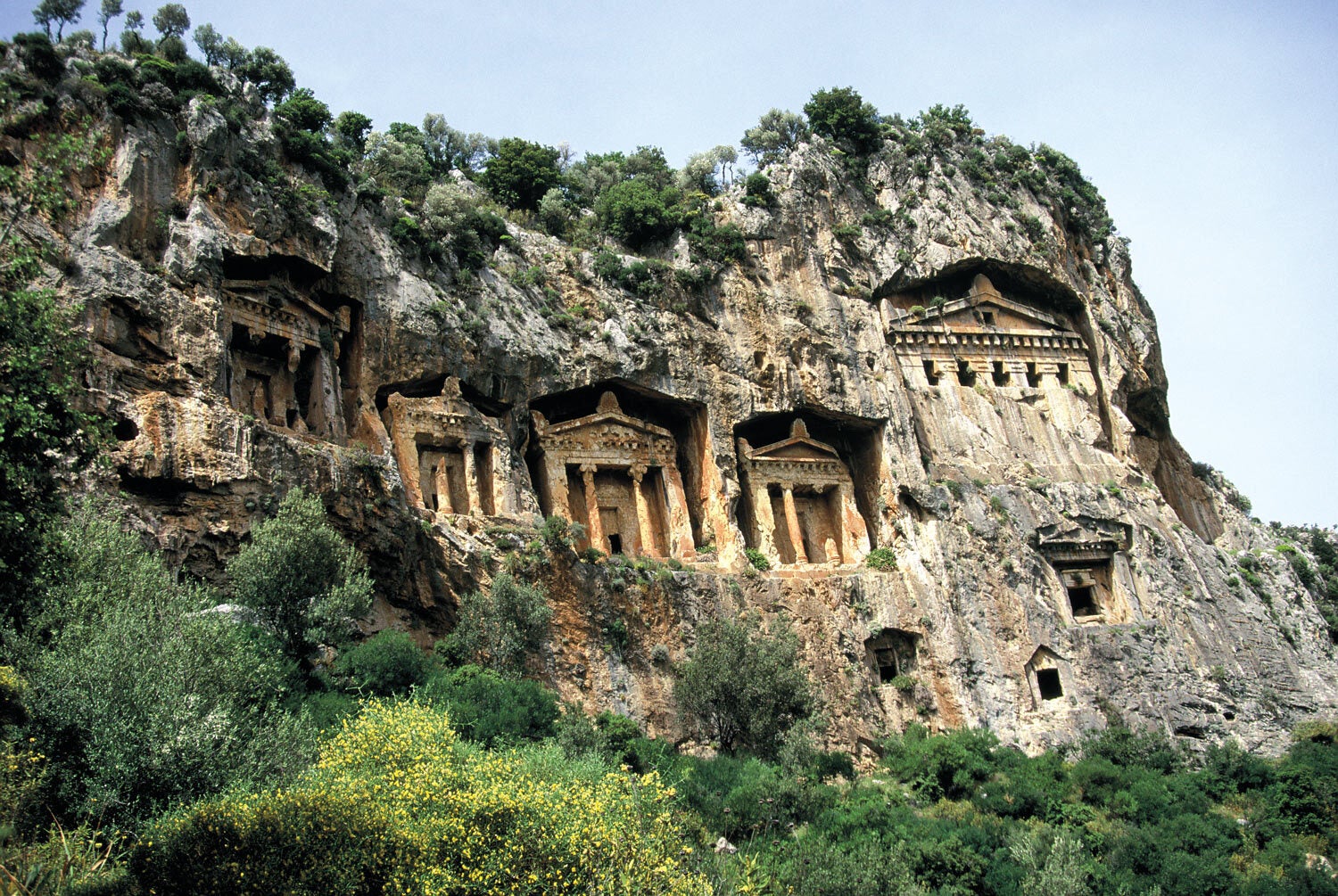 The ancient Lycian rock tombs carved into the cliffside are a must-see